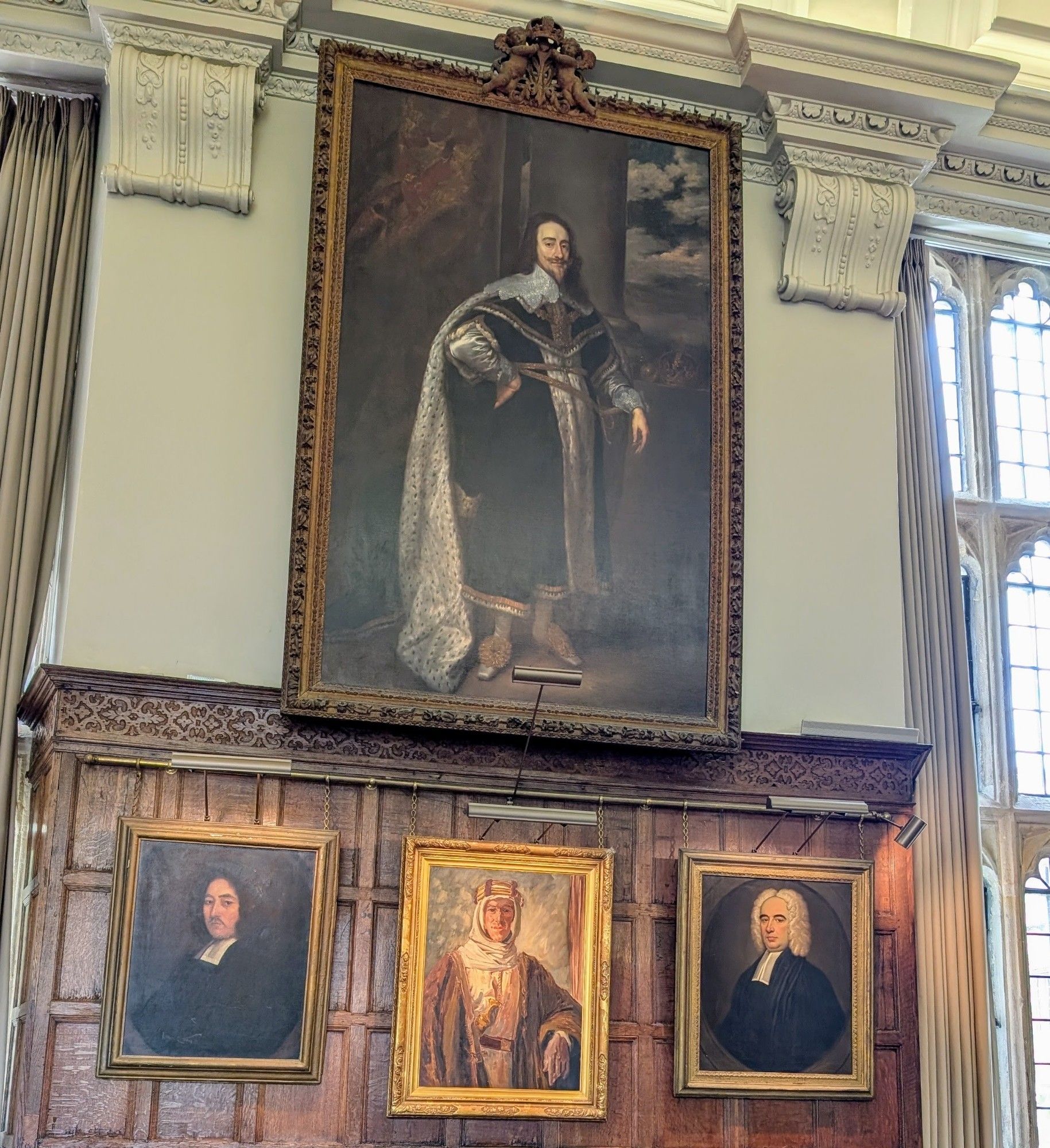 Four portraits, including a large one of king James I and VI (pretty sure), a smaller one of TE Lawrence in Arab dress, and 2 anonymous clergymen