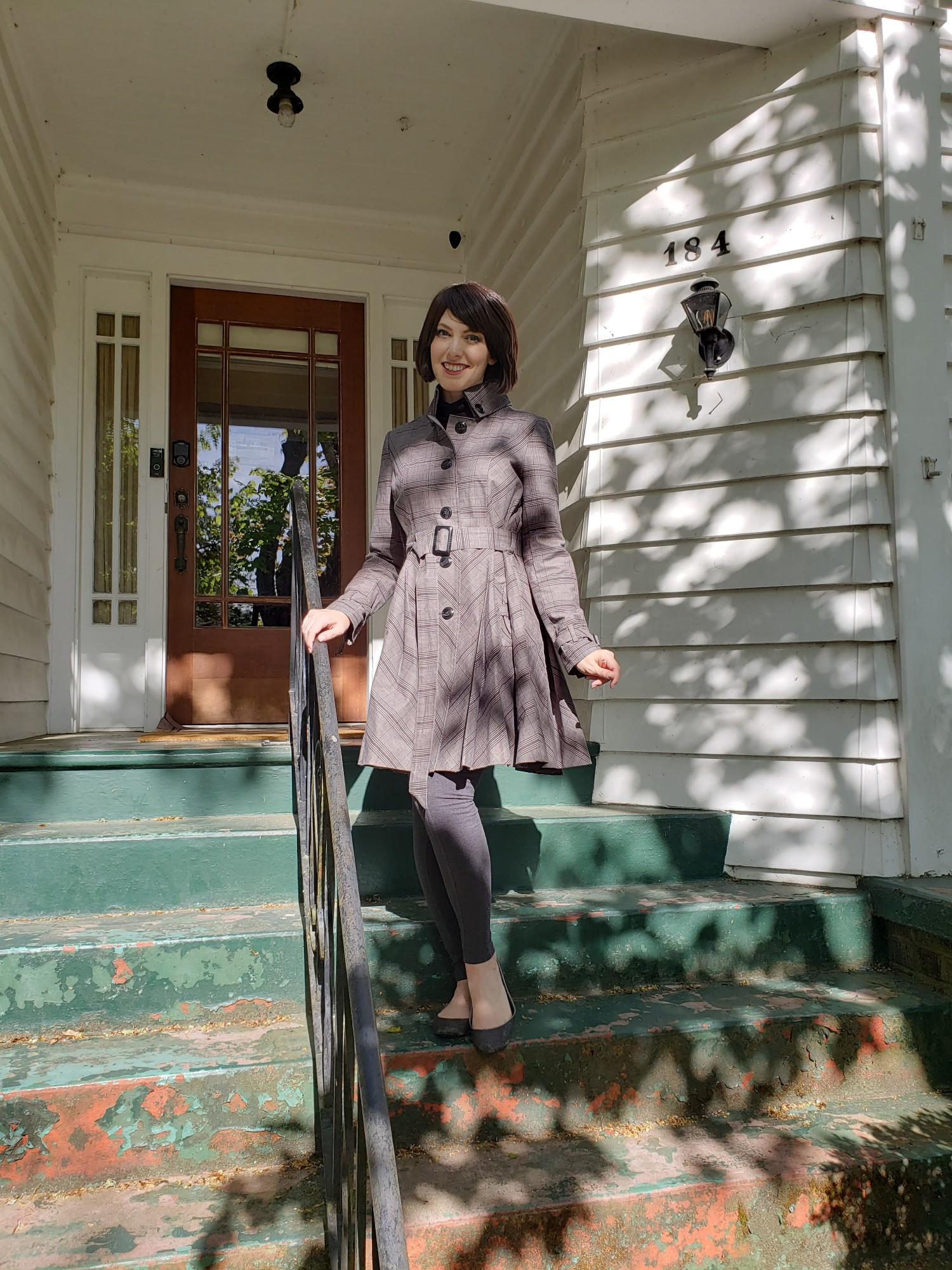 A photo of me dressed as Alice Cullen. I'm posing on the front steps of the Swan House that was featured in the first Twilight movie.