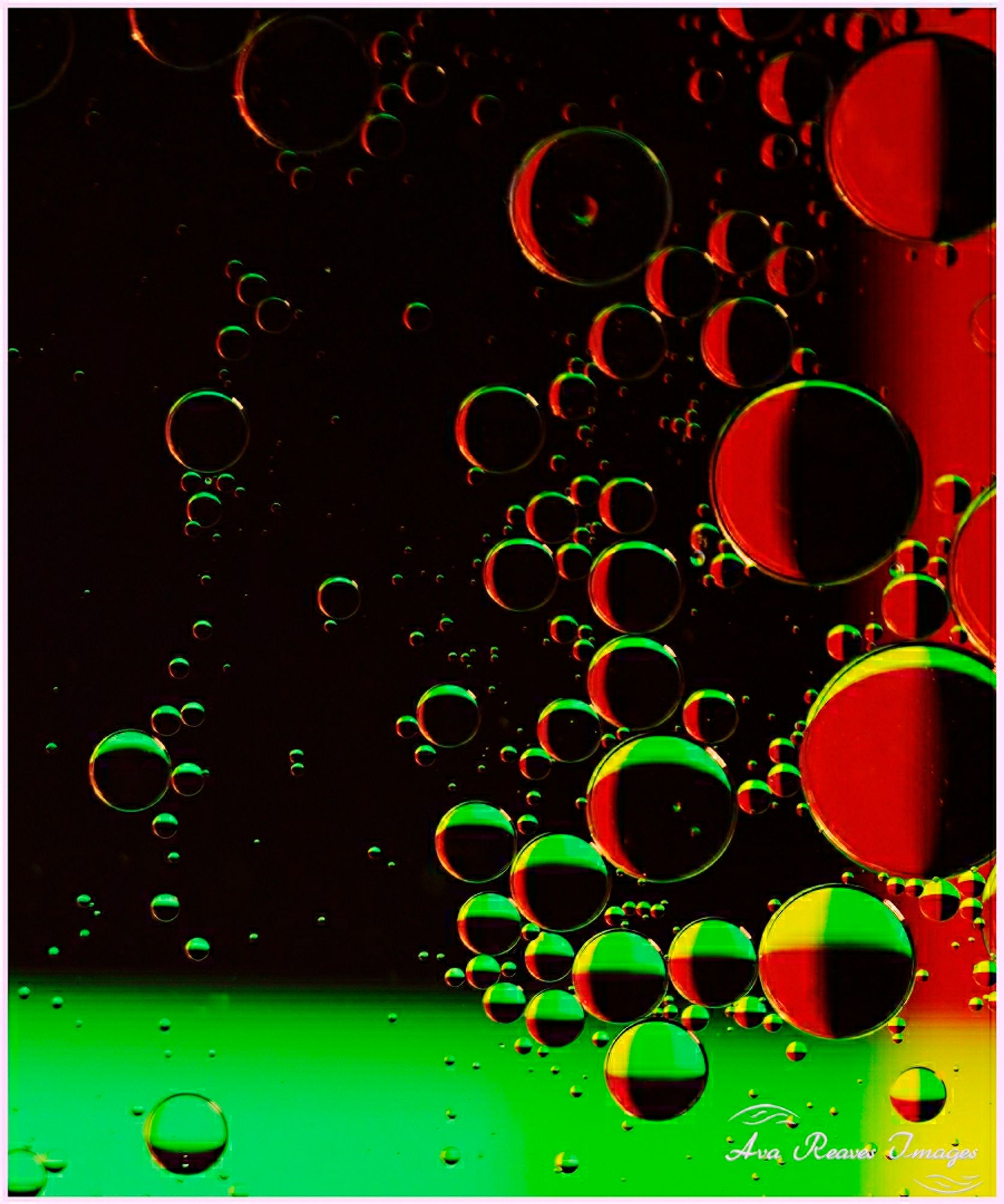 Oil and water within red, black, green and yellow backdrop