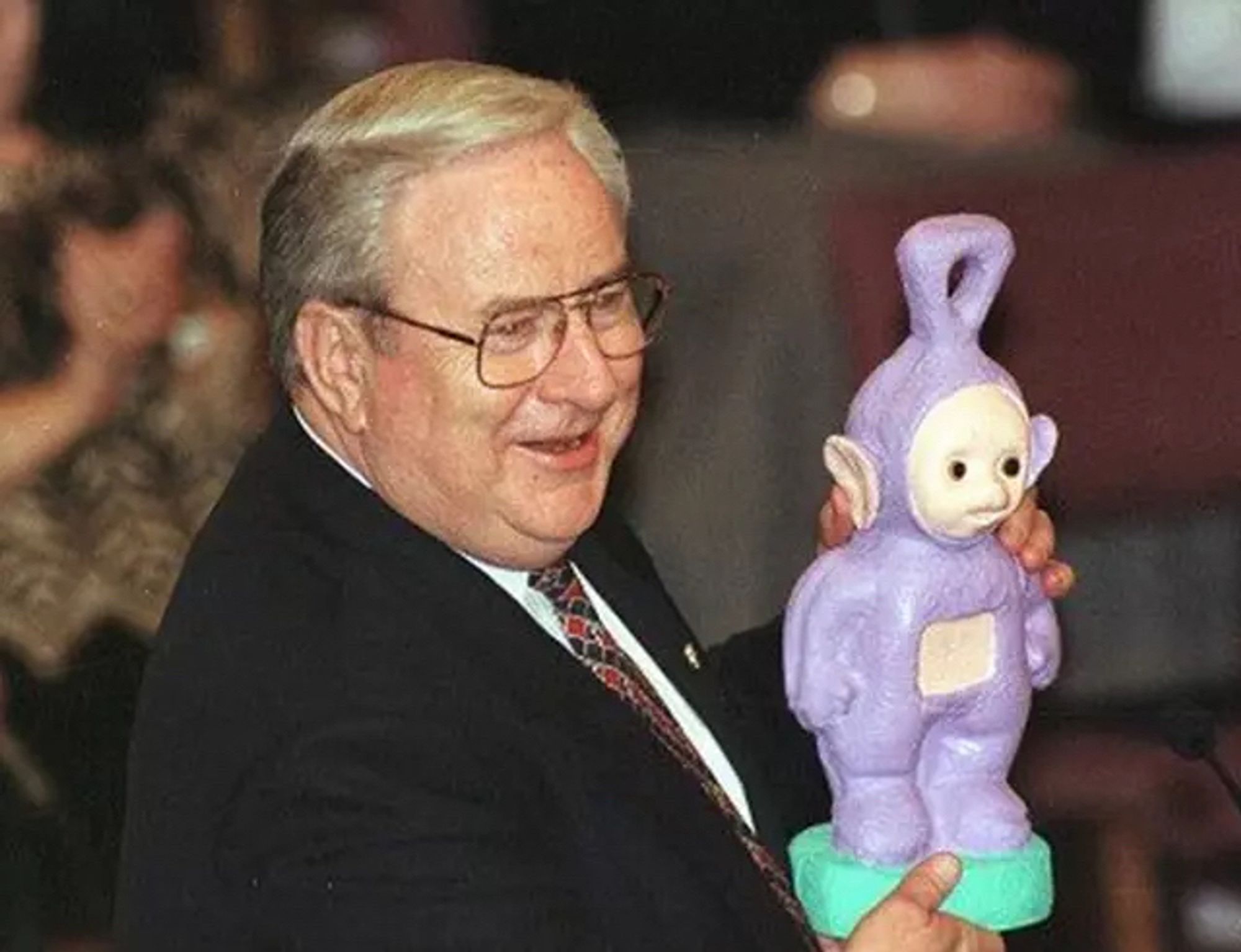 piece of shit Jerry Falwell holding up a Tinky Winky statue 