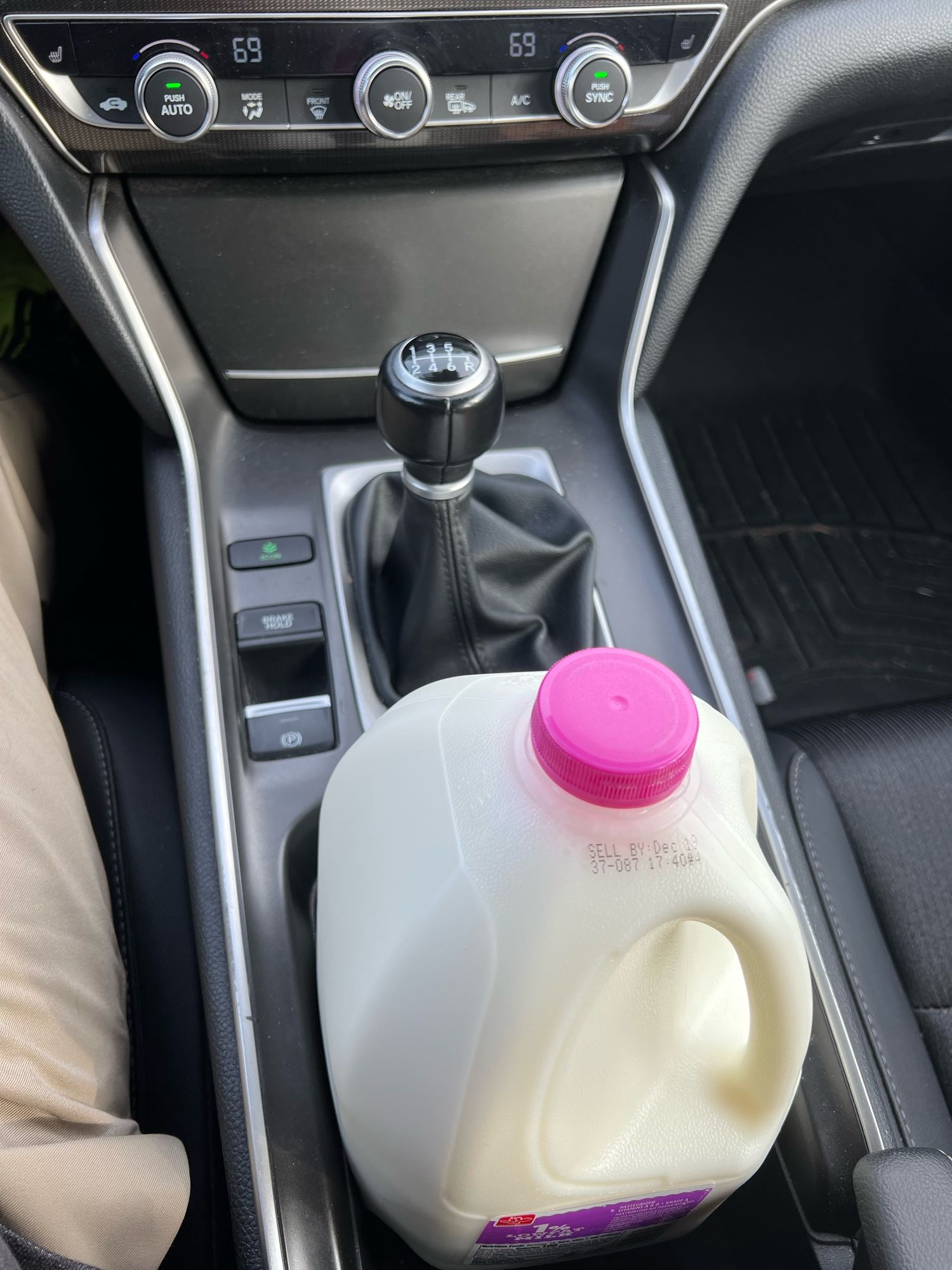 A gallon of milk in a he cup holder of a 2020 Honda Accord 2.0T MT