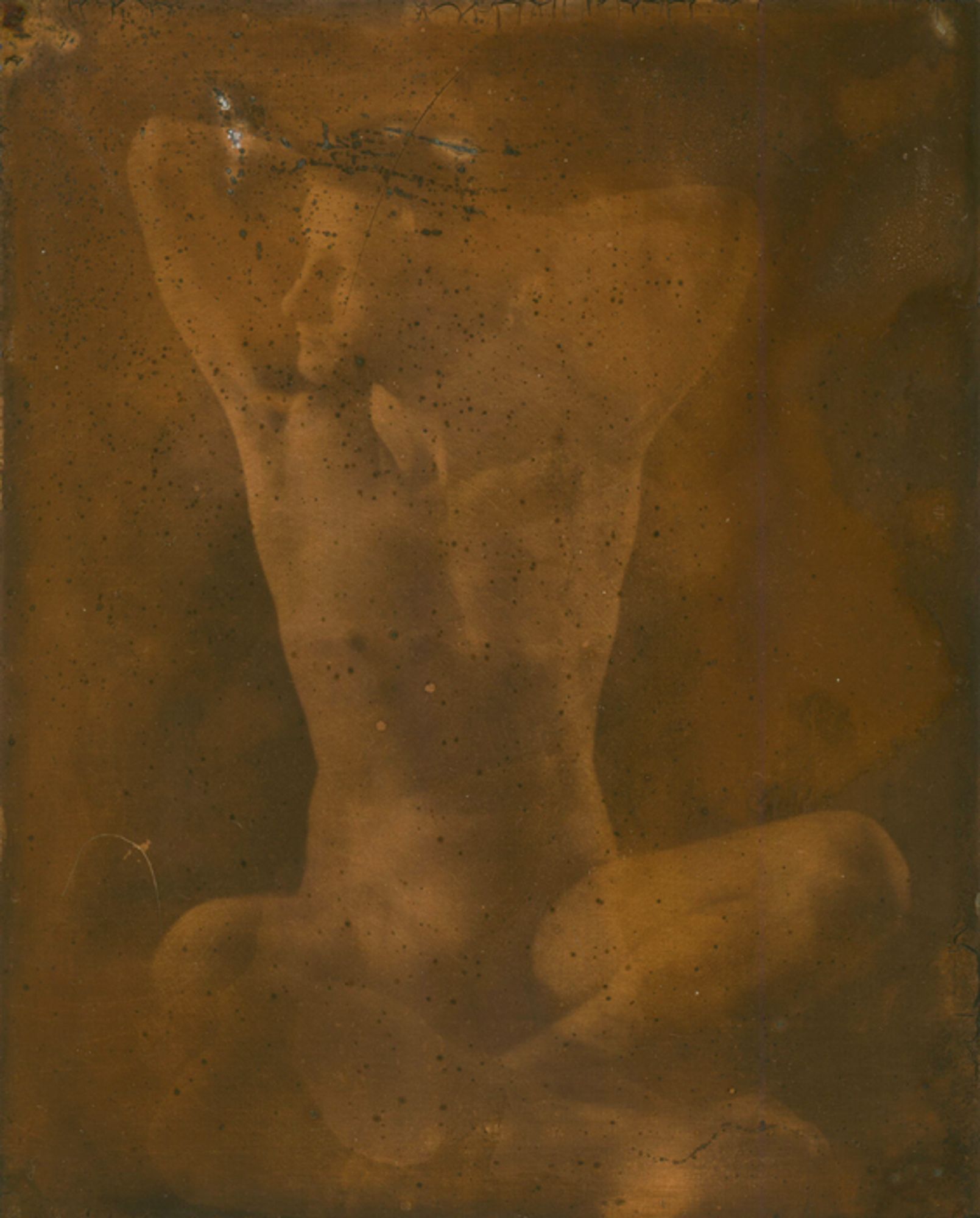 From Echo, a series of nudes printed on copper plates using a dark room and light sensitive coating. The image depicts a man sitting cross legged, his hands behind his head, looking off to the left of the frame. The image is heavily distorted by the process of its production.