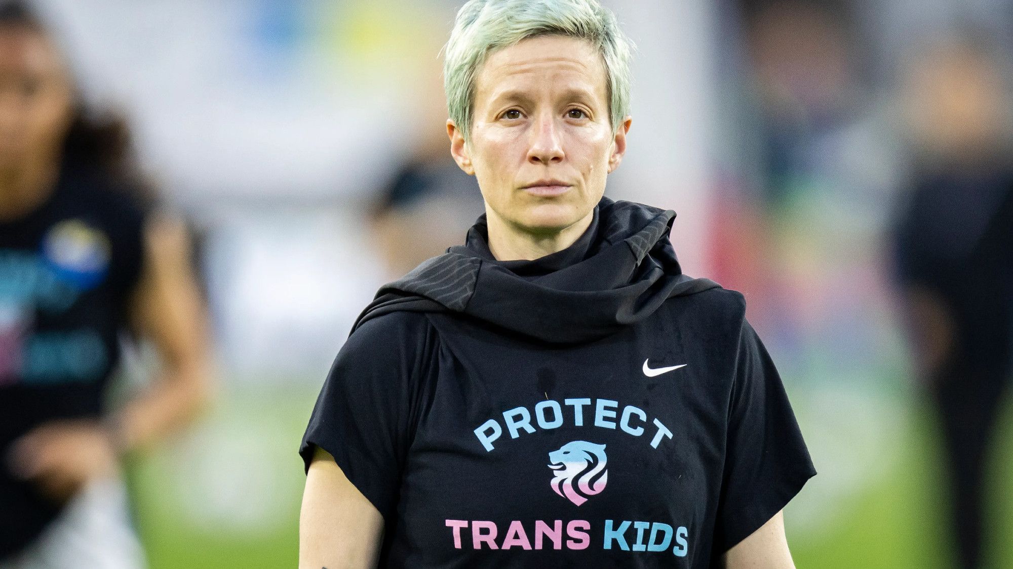 Image shows Megan Rapinoe wearing a 'Protect Trans kids' T shirt