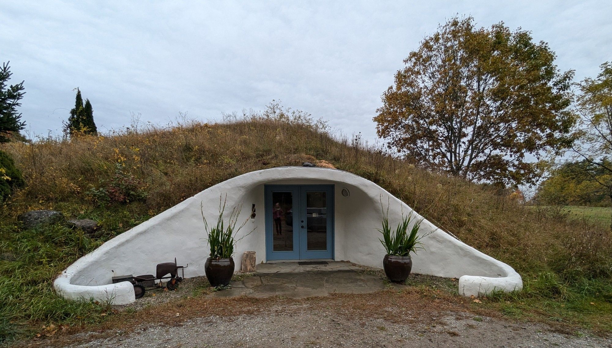 Entrance to a house/studio built into a hill reminiscent of a hobbit home. 