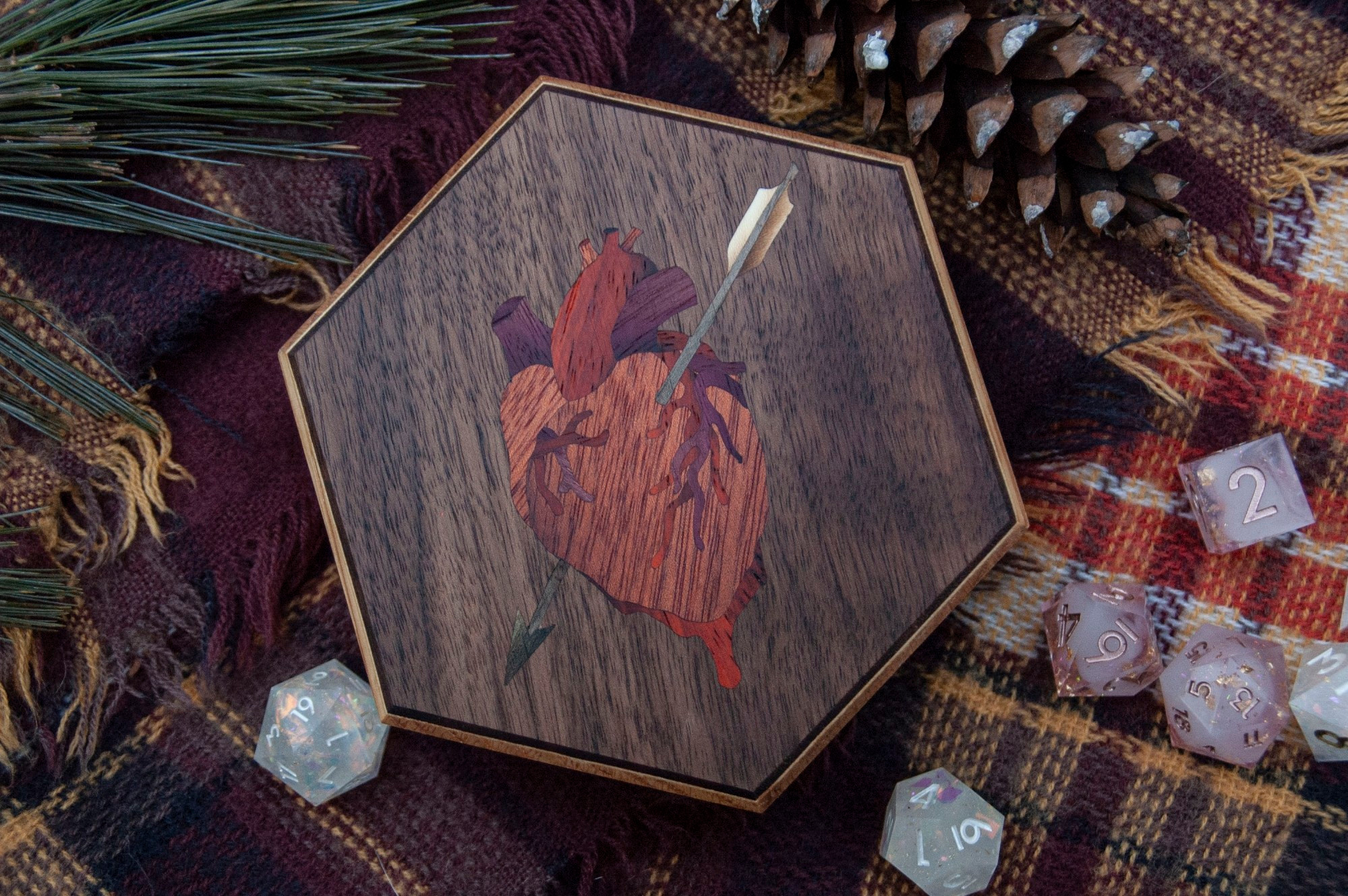 Hexagonal dice box with a marquetry anatomically correct heart being pierced by a white fletched arrow.