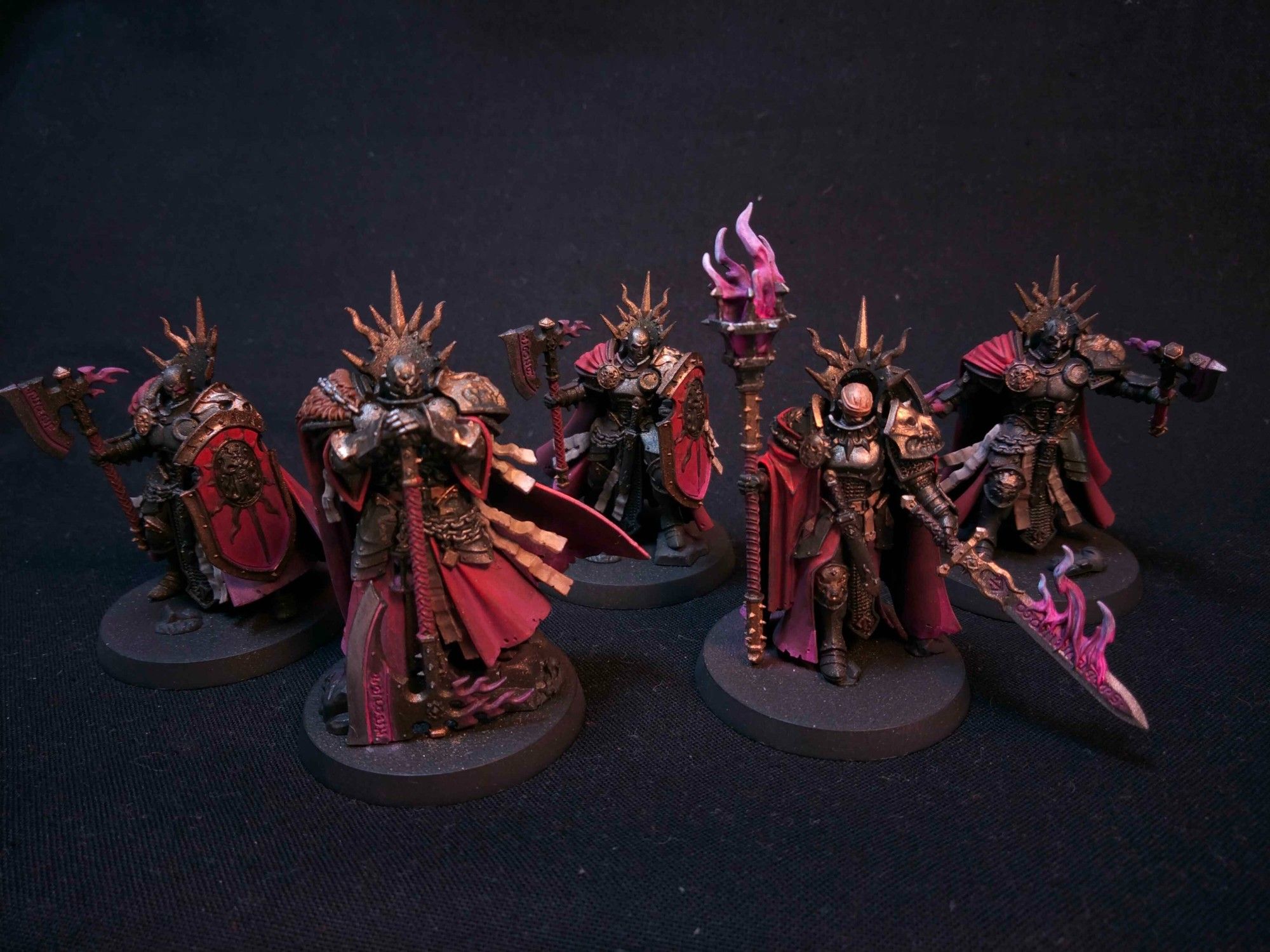 5 Stormcast elites, with dark armour, gold trimmings and dark red-purple cloths.