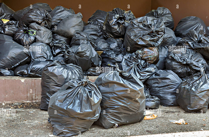 photograph of a pile of trash bags