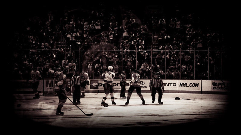 photo of jody shelley of the philadelphia flyers and derek boogaard of the new york rangers squaring off in a hockey fight as players, referees, and fans look on