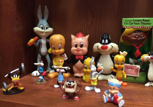 Some small PVC figures from 1992 of Daffy Duck, Wile E. Coyote, Sylvester (and Tweety), Bugs Bunny, and Porky Pig in fitness related activities.  Behind the PVC figures are some Dakin figures, all circa 1976.  Bugs Bunny and Tweety are hard plastic figures with jointed arms and legs, although Tweety is less jointed then the ones in the previous pictures as his arms are fused to his body.  The chubby Porky Pig and Sylvester are coin banks.  Speedy Gonzales is a jointed figure but smaller than the one in the previous photo, does not have cloth clothing, and is in its original box.  The Sylvester and Tweety figures in front of the boxed Speedy Gonzales are hard rubber figures.  The Tweety between Porky Pig and Sylvester is a finger puppet.