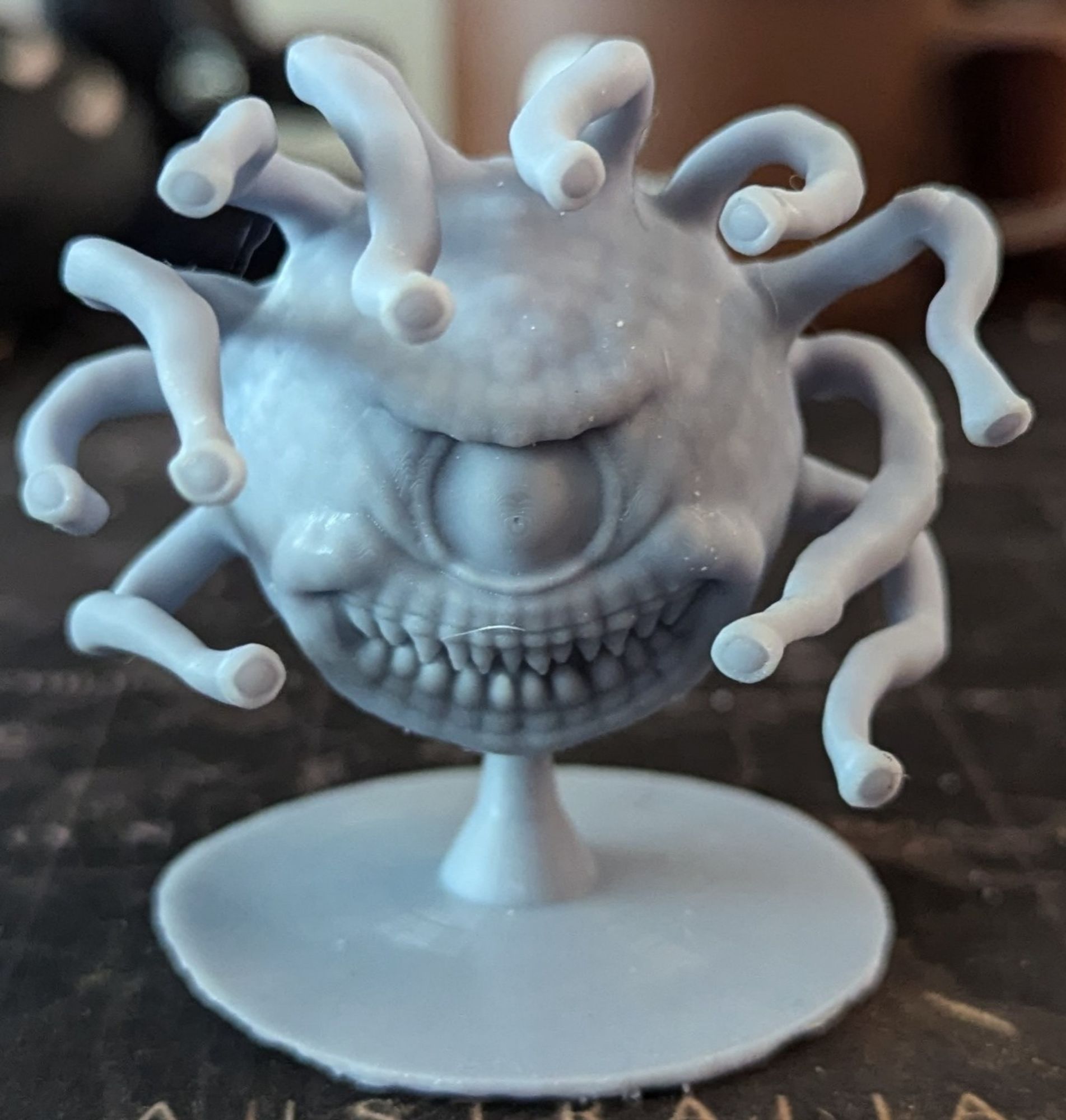 A washed and cured resin 3D print of a Beholder.