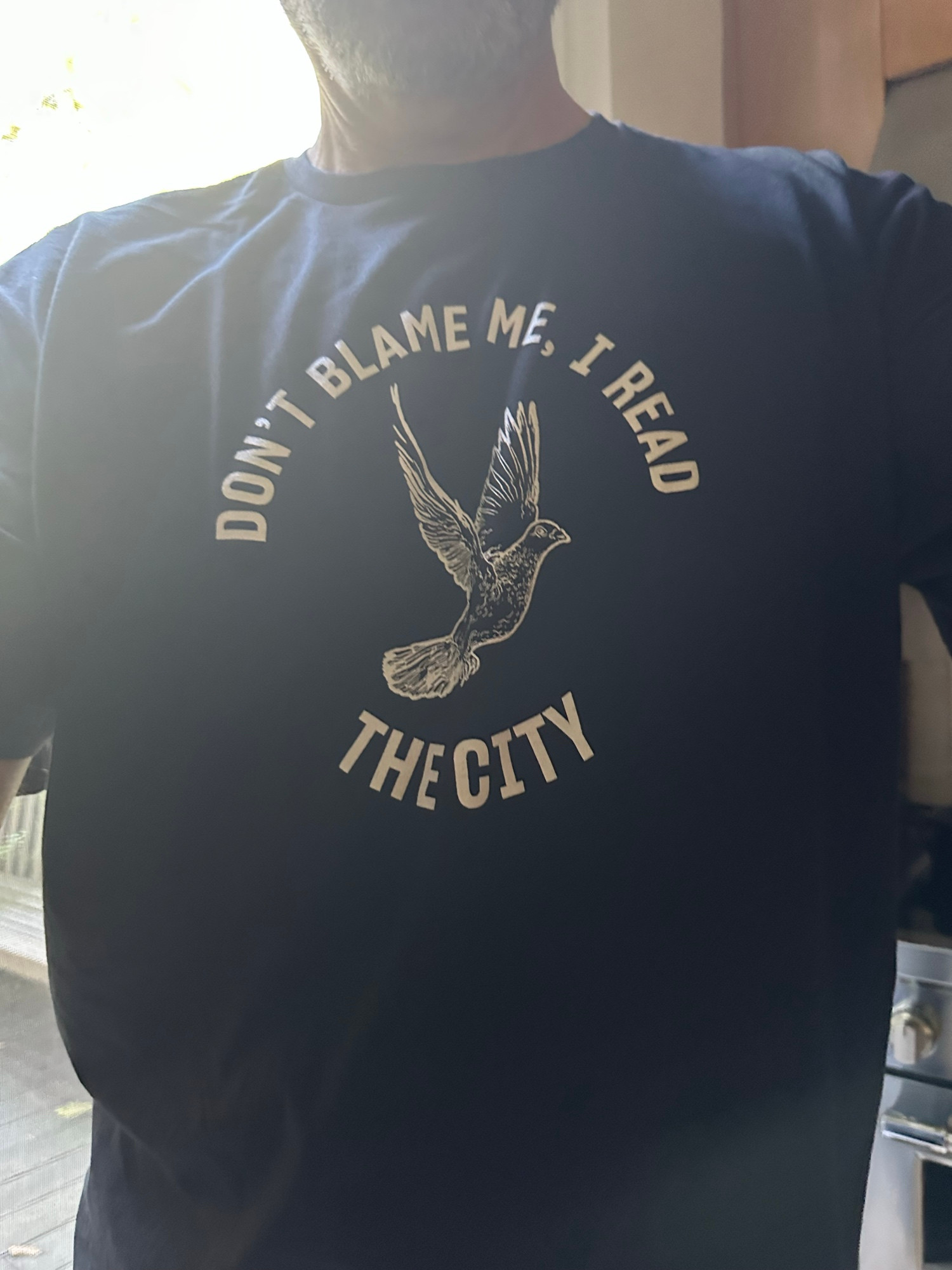 T shirt inscribed “don’t blame me, I read the city”