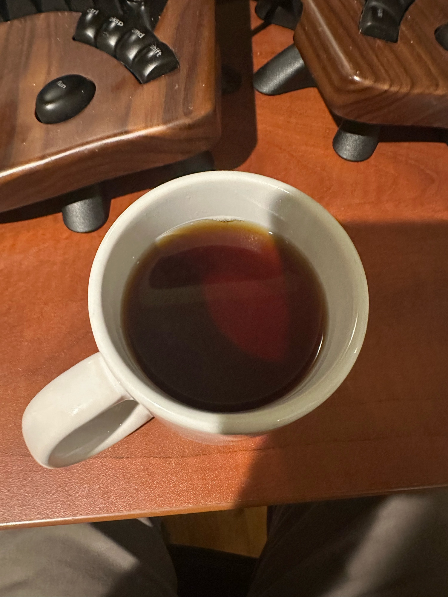 White ceramic mug filled with a darkly translucent black tea