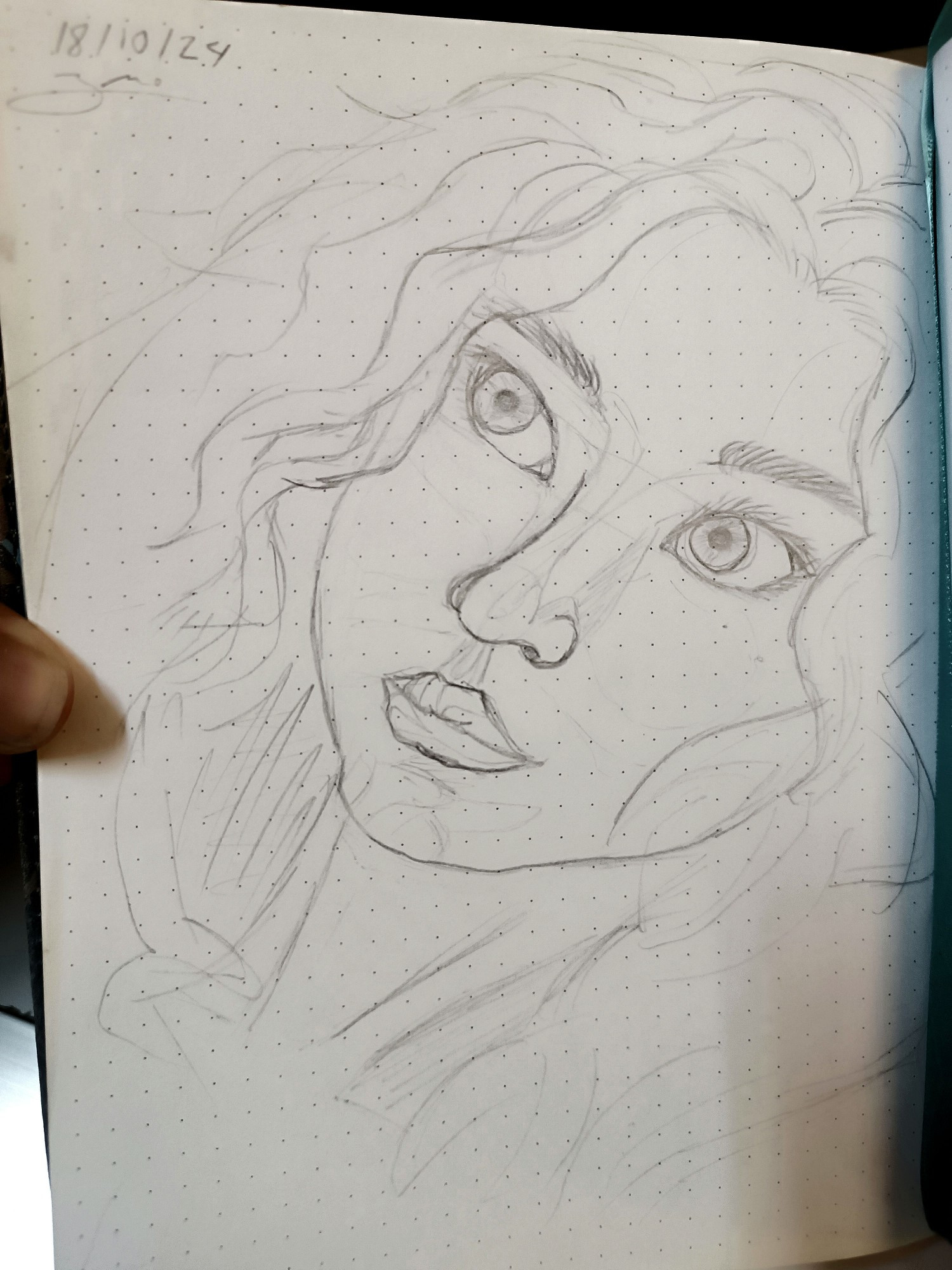 Pencil sketch of a feminine face with hints of curly hair. 