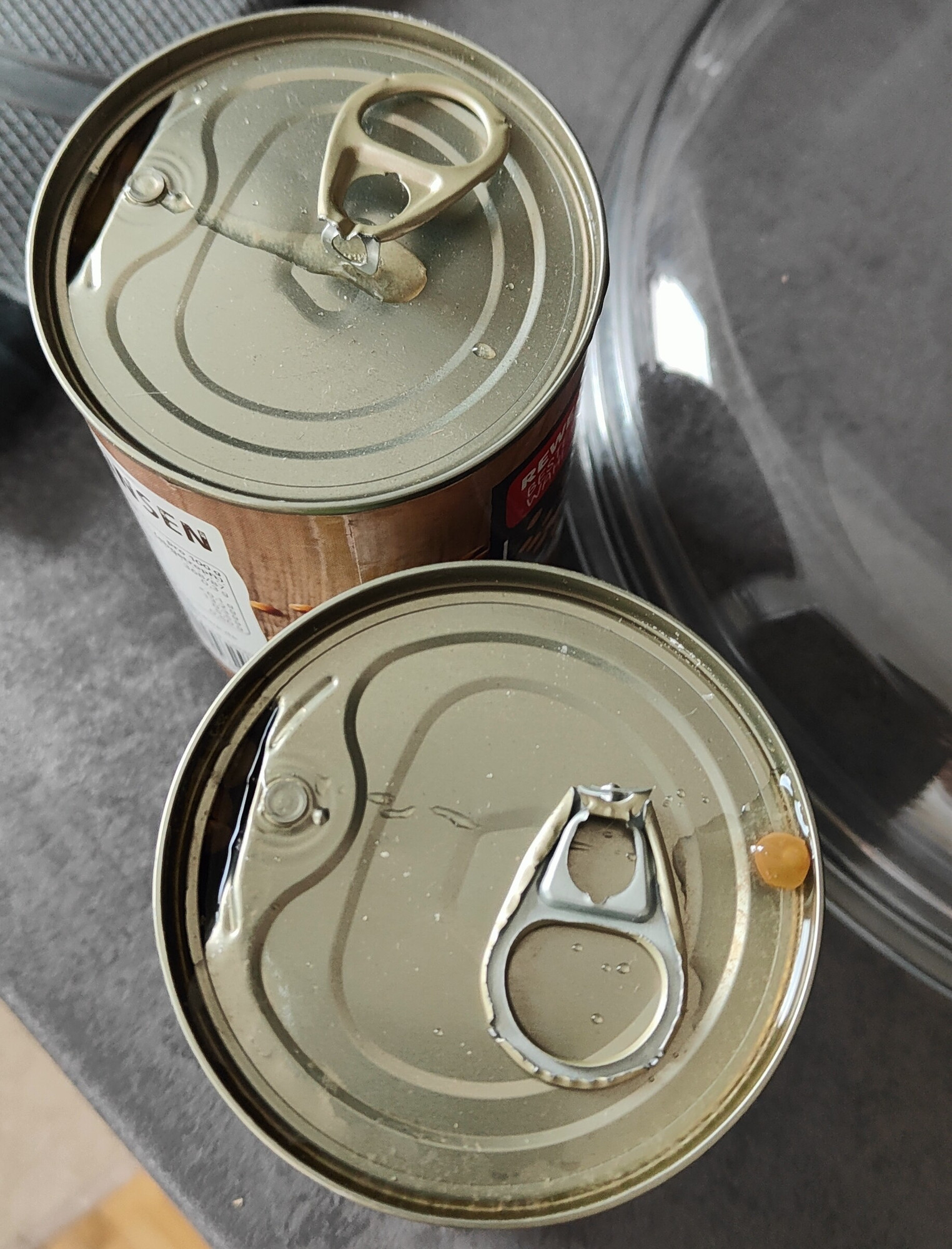 2 partly open cans where both of the fucking ring pulls have snapped off,the bastards.