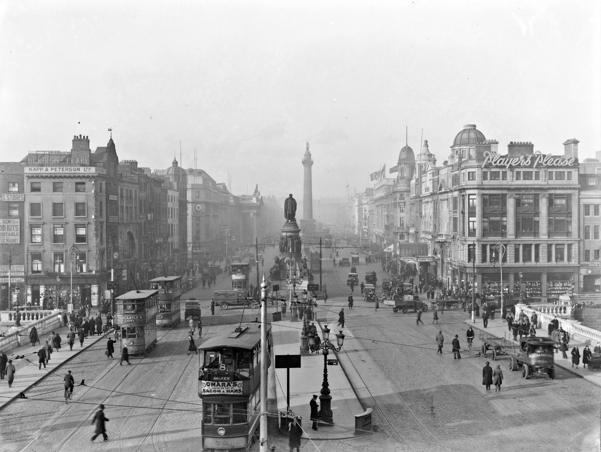 O'Connell Bridge from the south side looking up O'Connell Street towards Nelson's Pillar, Dublin, Ireland. 1932. The National Library of Ireland. No known copyright restrictions.