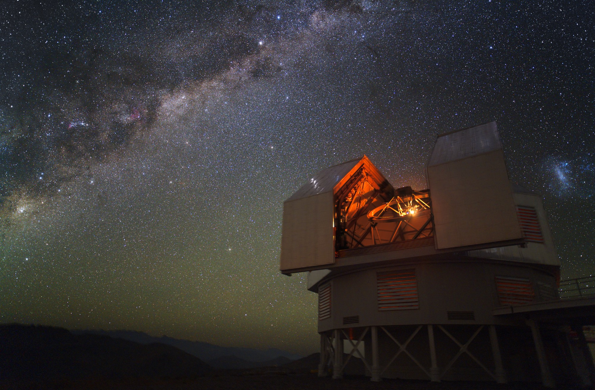 A view of the Milky Way over the Magellan Baade telescope at Las Campanas Observatory.