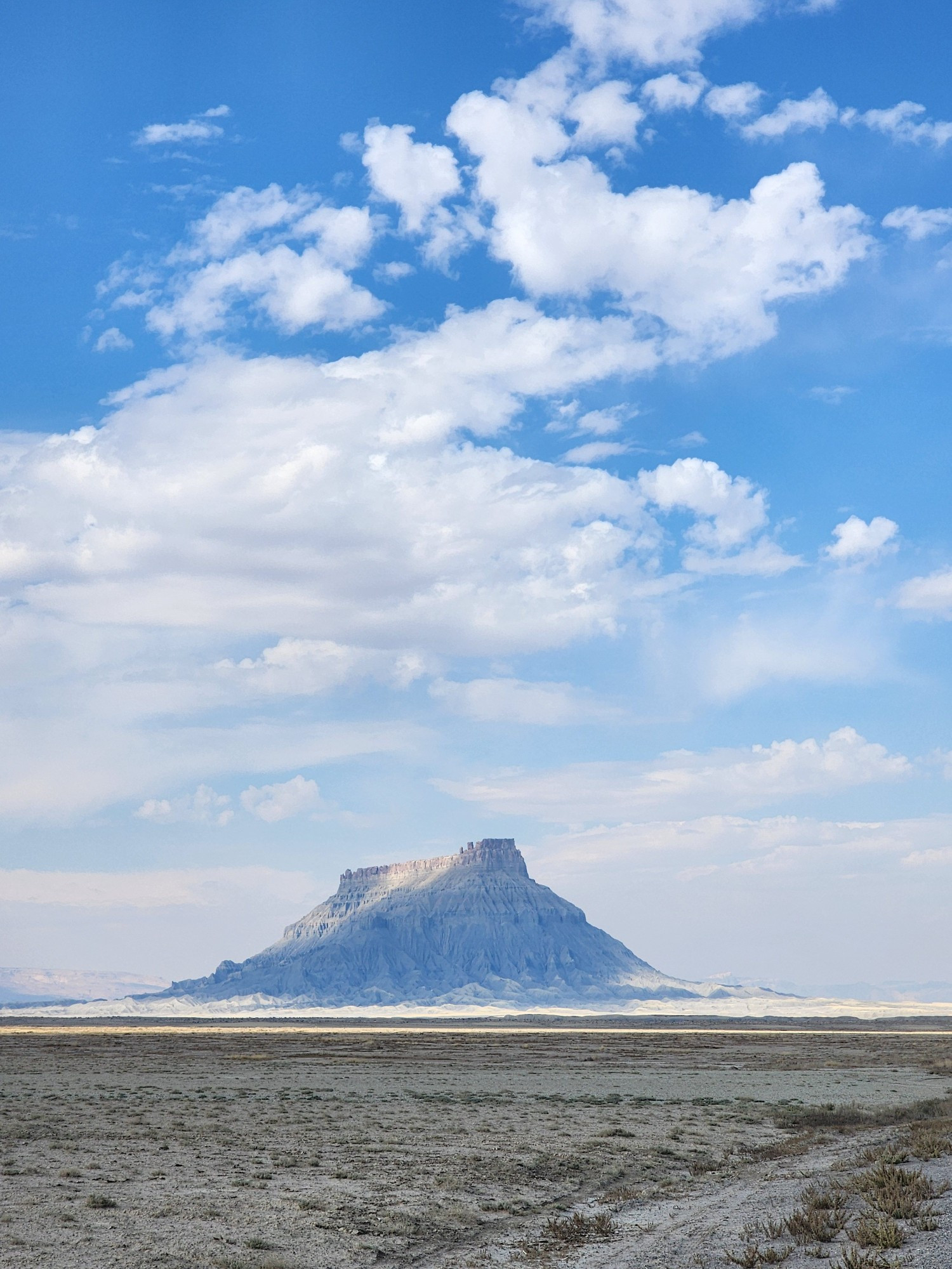 A view of Factory Butte jutting out in the distance