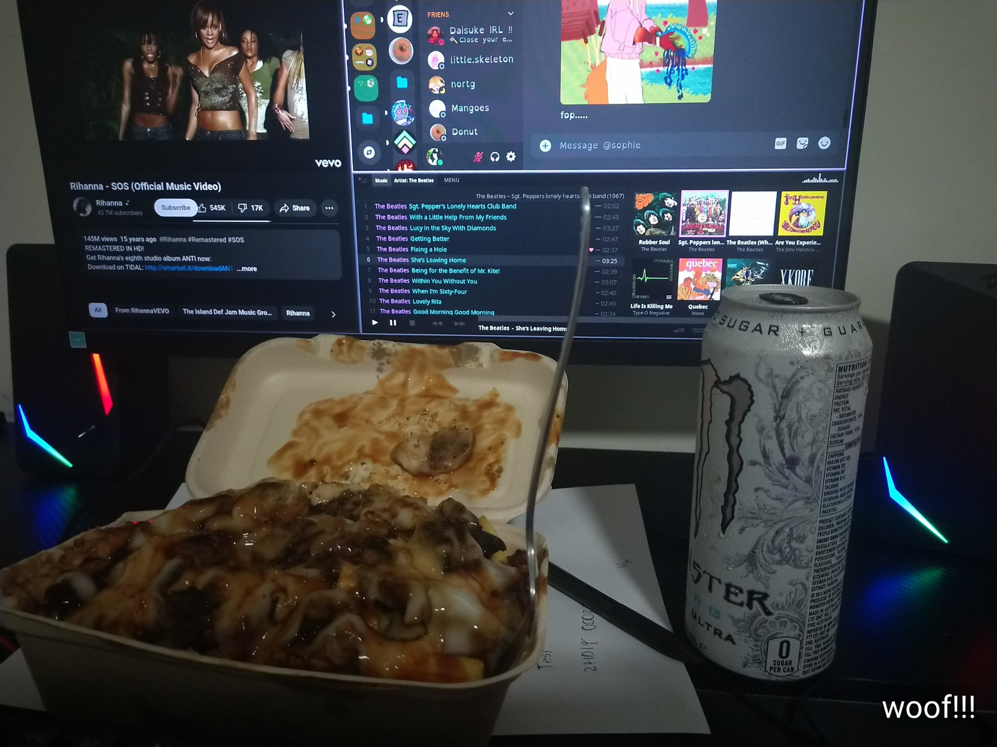 a halal snack pack and can of white monster sitting in front of a computer. the computer has "SOS - Rihanna" playing, and a music player and discord client open