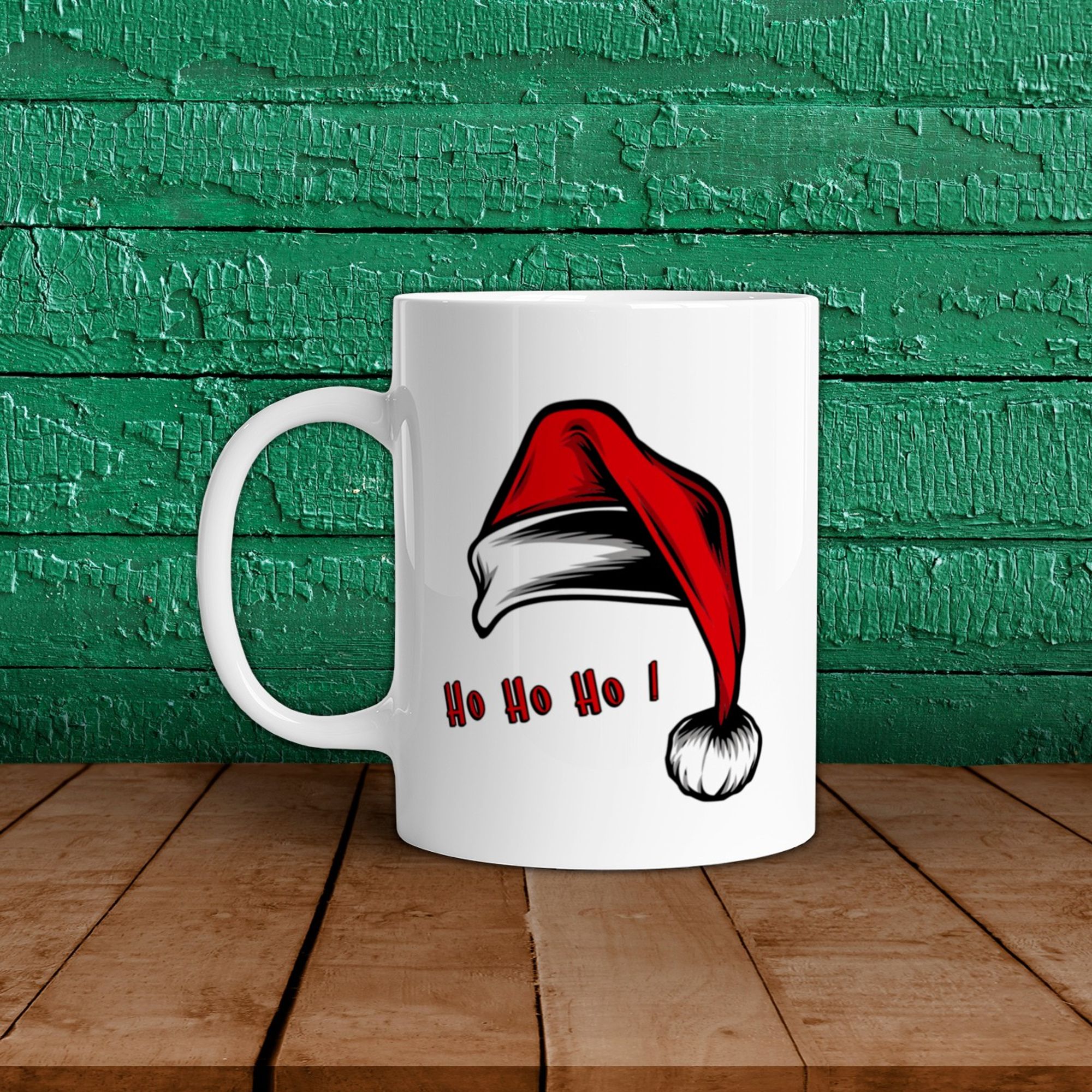 Mug de Noël blanc ayant pour motif un gros bonnet de Noël rouge et son pompon et le texte "Ho ho ho"