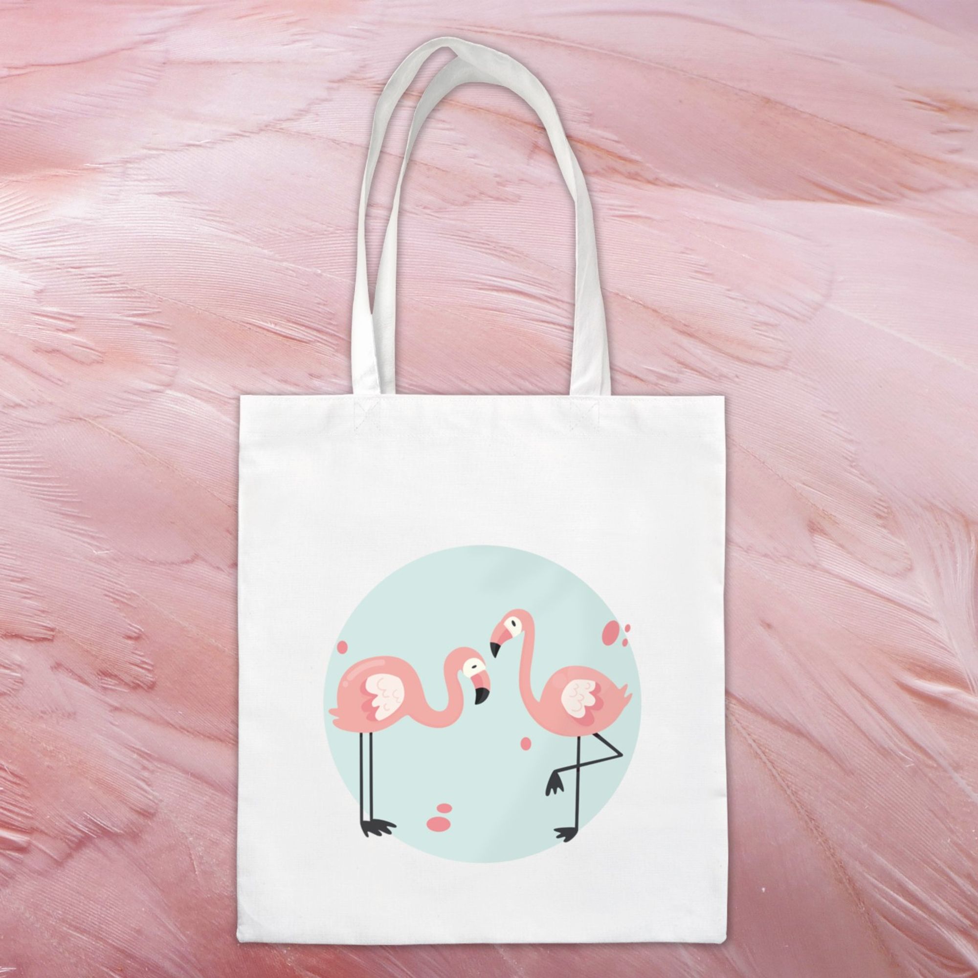 Tote bag 100% coton représentant deux flamants roses sur fond bleu.