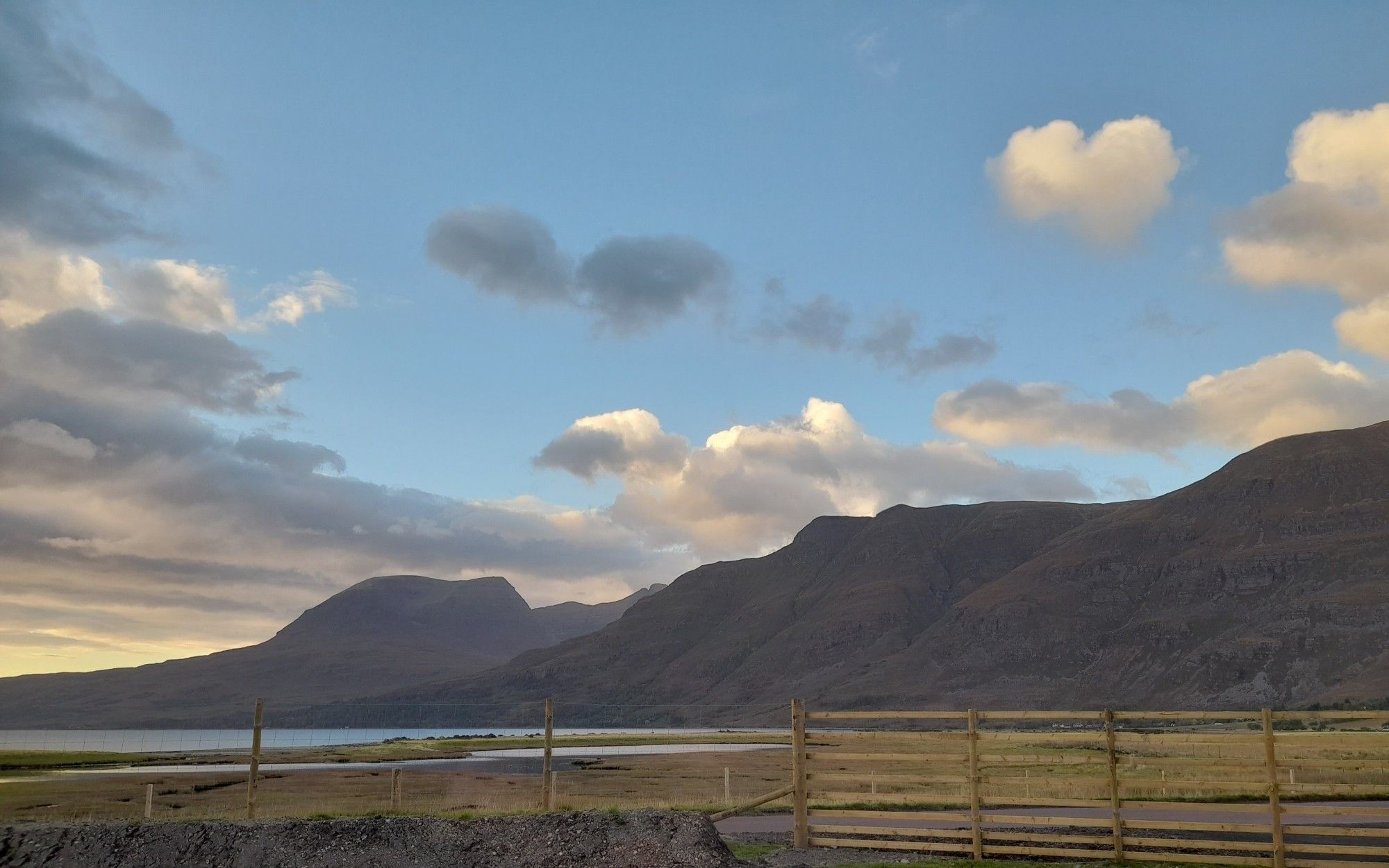 A photo of Beinn Alligin and rhe west end of Liathach with a peek of Upper Loch Torridon. Photo by and copyright of Lynn Henni.