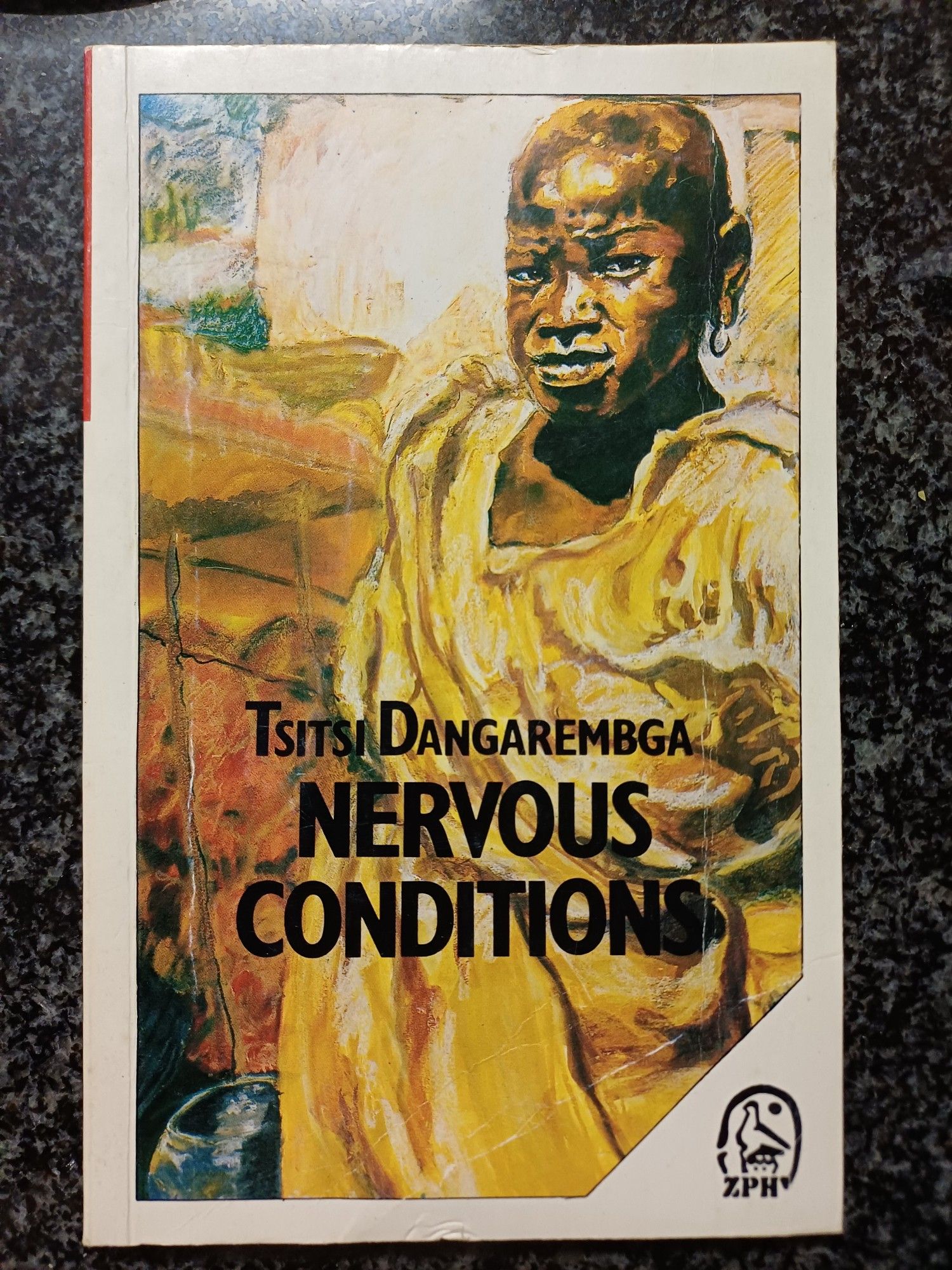 Zimbabwe Publishing House edition of Tsitsi Dangarembga's "Nervous Conditions" (1988); cover art by Claudette Johnson is a drawing of Black woman wearing a beige clothing item wrapped in voluminous folds obscuring the shape of her body; she looks directly at the viewer, and an earring dangles from her left lobe; author name and book title appear in bold black capitals over the image in the lower half of the frame; the publishing house logo, a styliaed icon of the Zimbabwe Bird atop the letters Z, P, and H,  appears in the lower right hand corner of the cover.