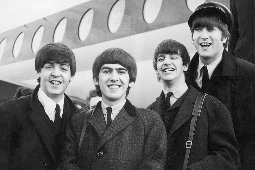 The Beatles in 1964: all of them have hair reaching their collars; John's hair reaches below his eyebrows.