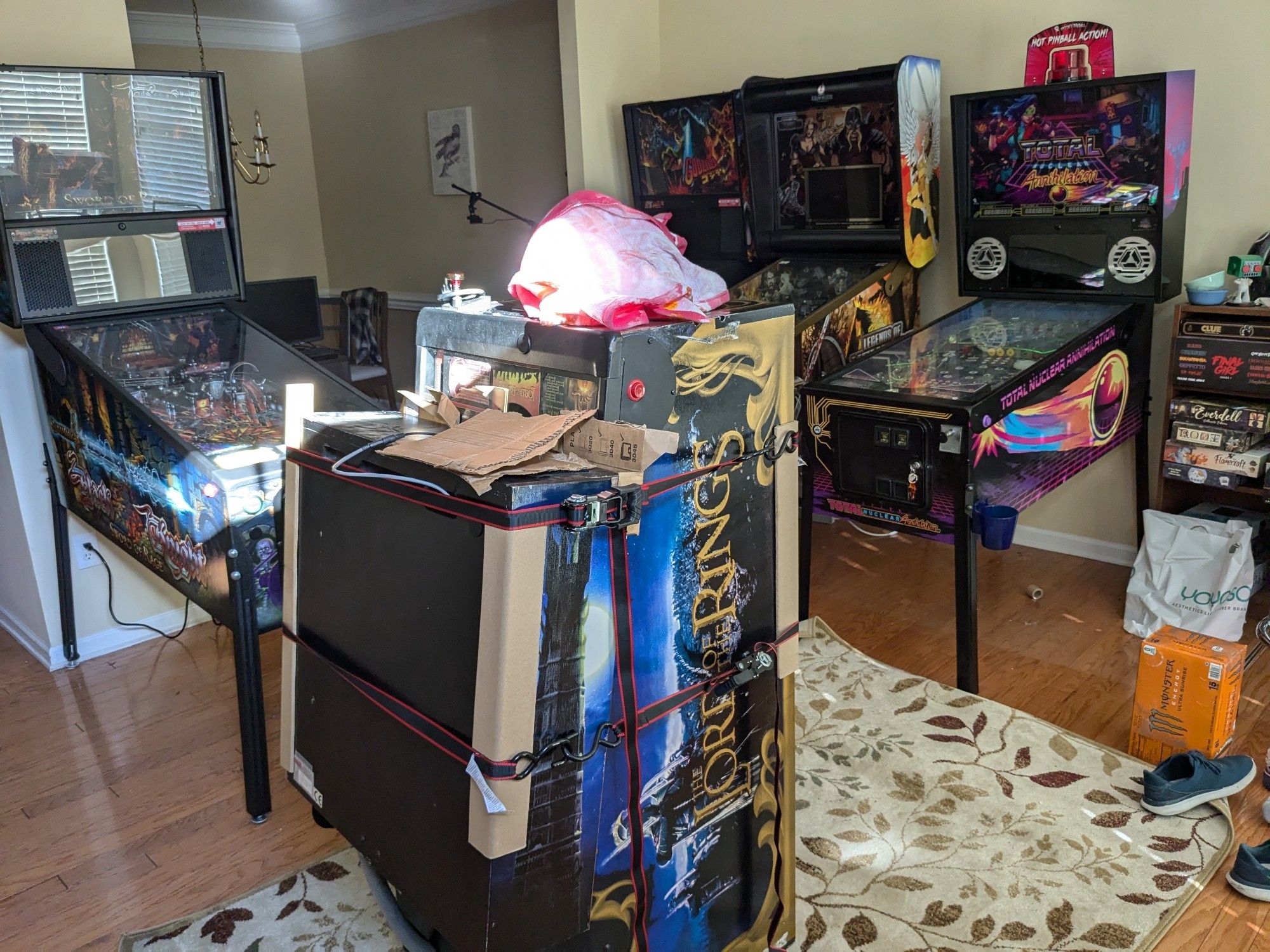 A LOTR pinball machine wrapped up in a living room