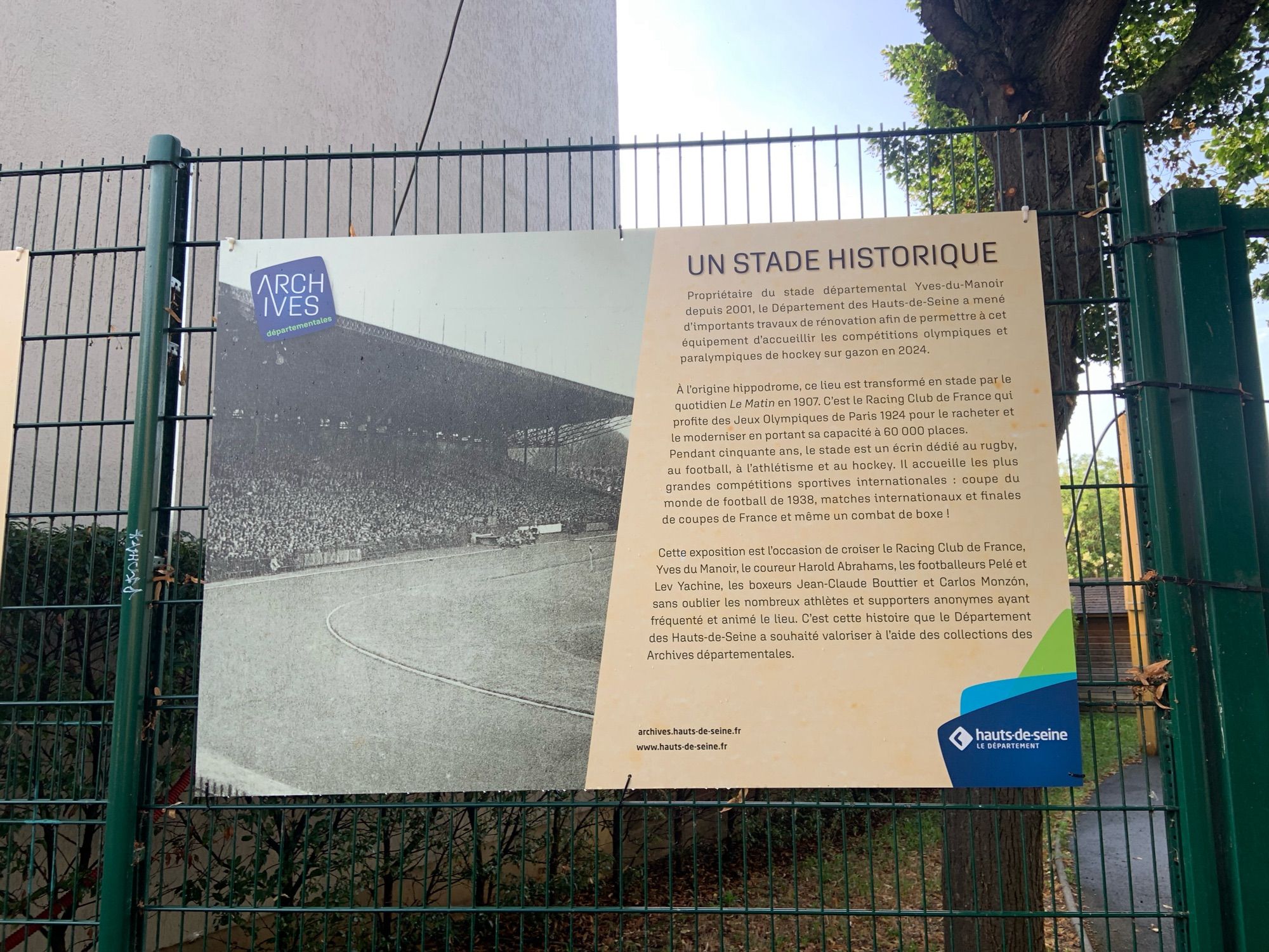 First board with photo of historic full stands and an explanation of the sport heritage walk