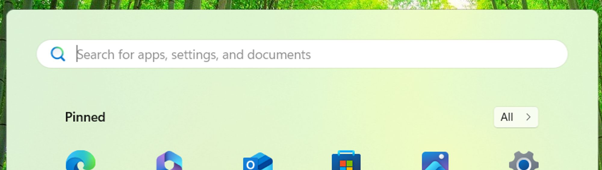 Top of the Start menu in Windows 11. A search box, Pinned header and All button are visible.