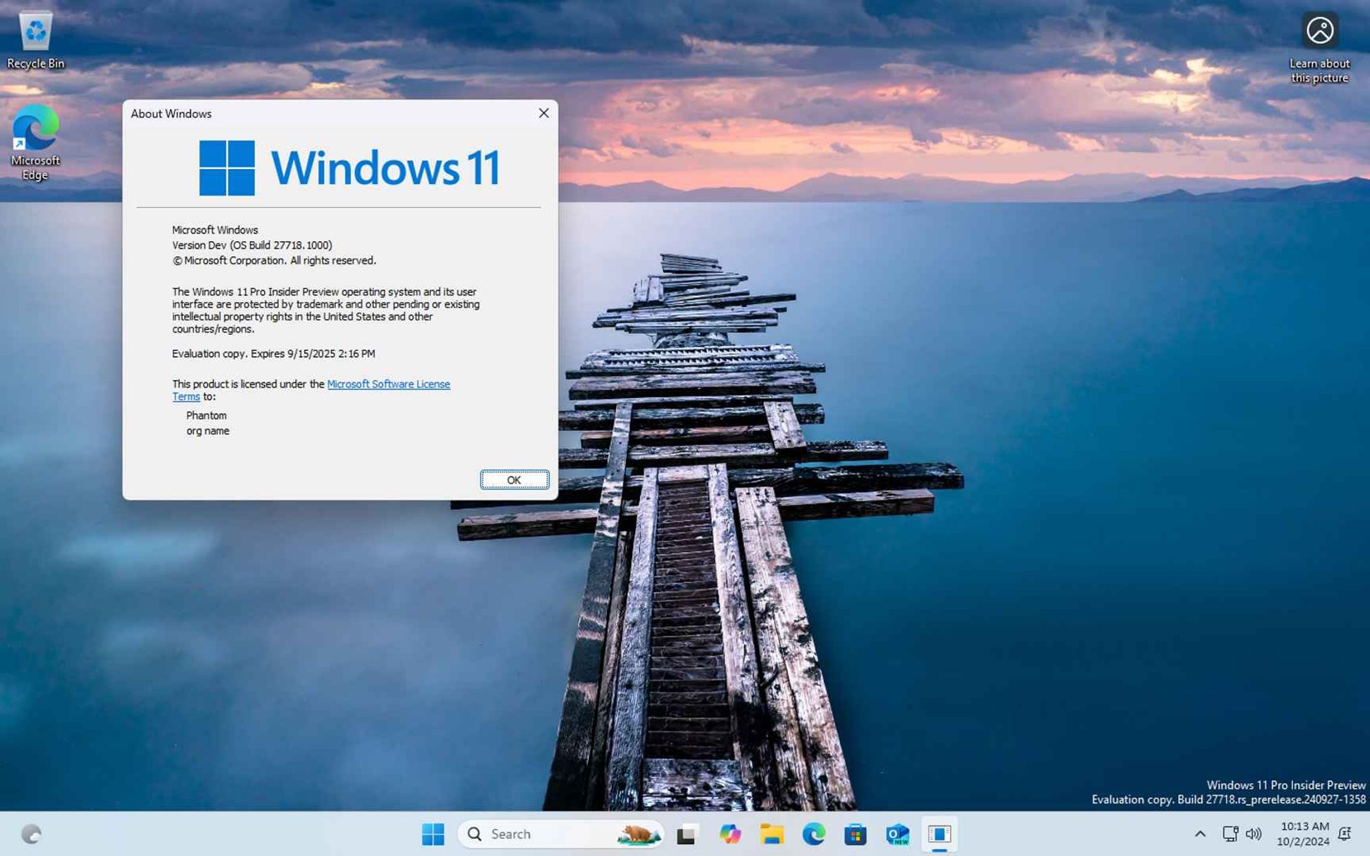 Windows 11 build 27718 desktop with About Windows (Winver) open, showing that the currently installed version is Version Dev.