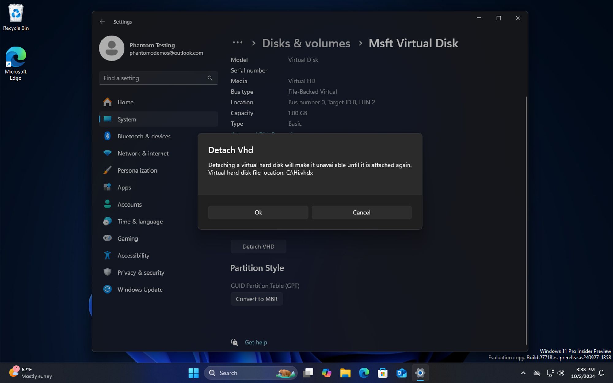 Windows 11 build 27718 desktop with the Settings app open. The user is in the process of detaching a VHD, and has been presented with a dialog letting them know where the VHD is stored.