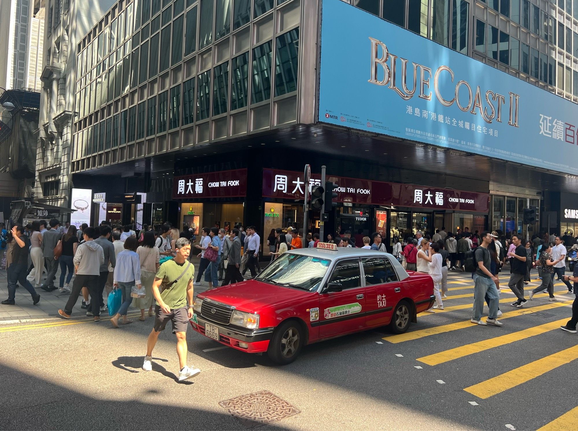 Taxi in the middle of a crosswalk waits for the next green light