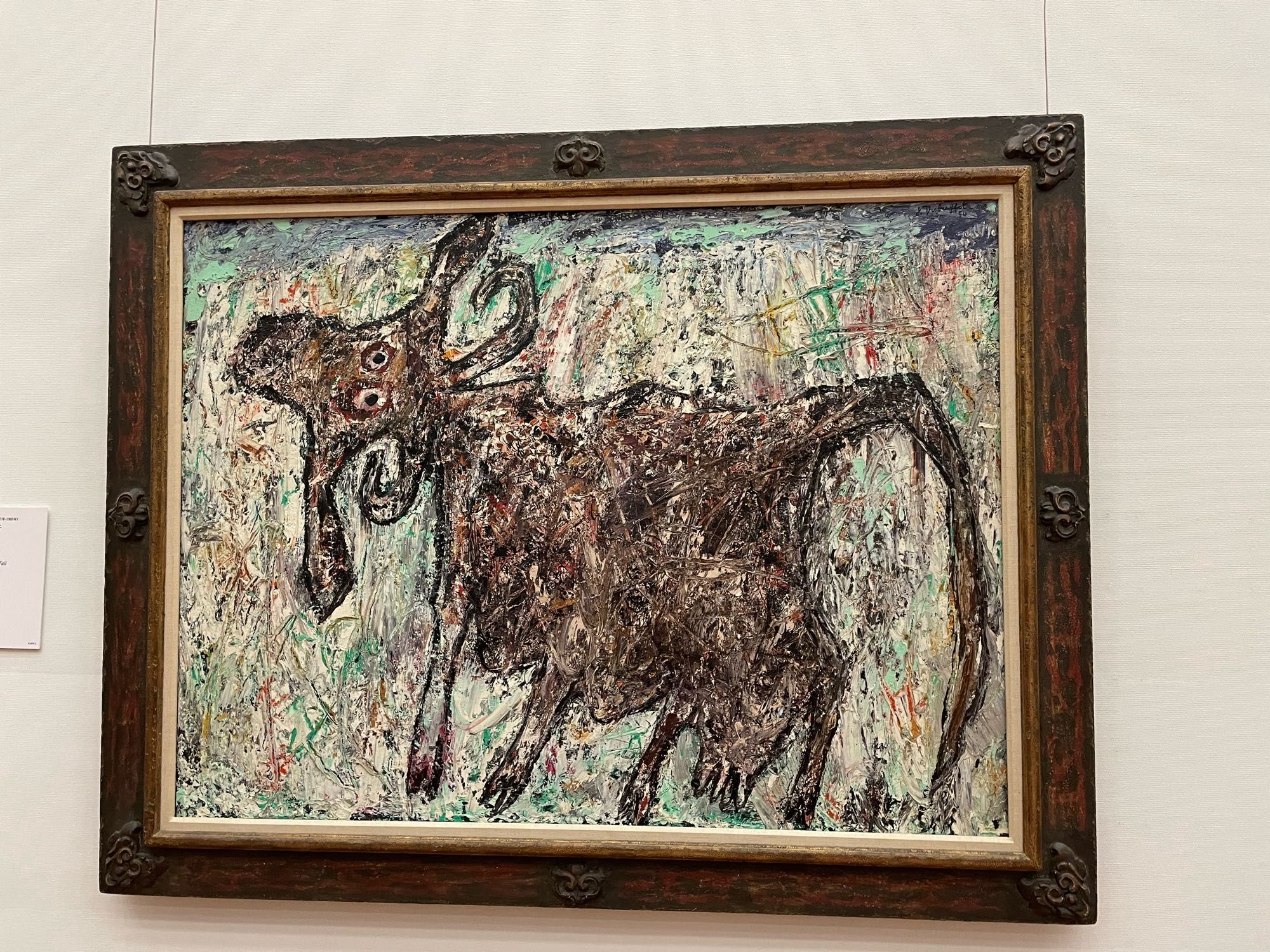 Title of the painting is cow with a beautiful tail. The angle of the painting is from the top of the head, one dimensional view from the side and them a tail growing out of its mid back