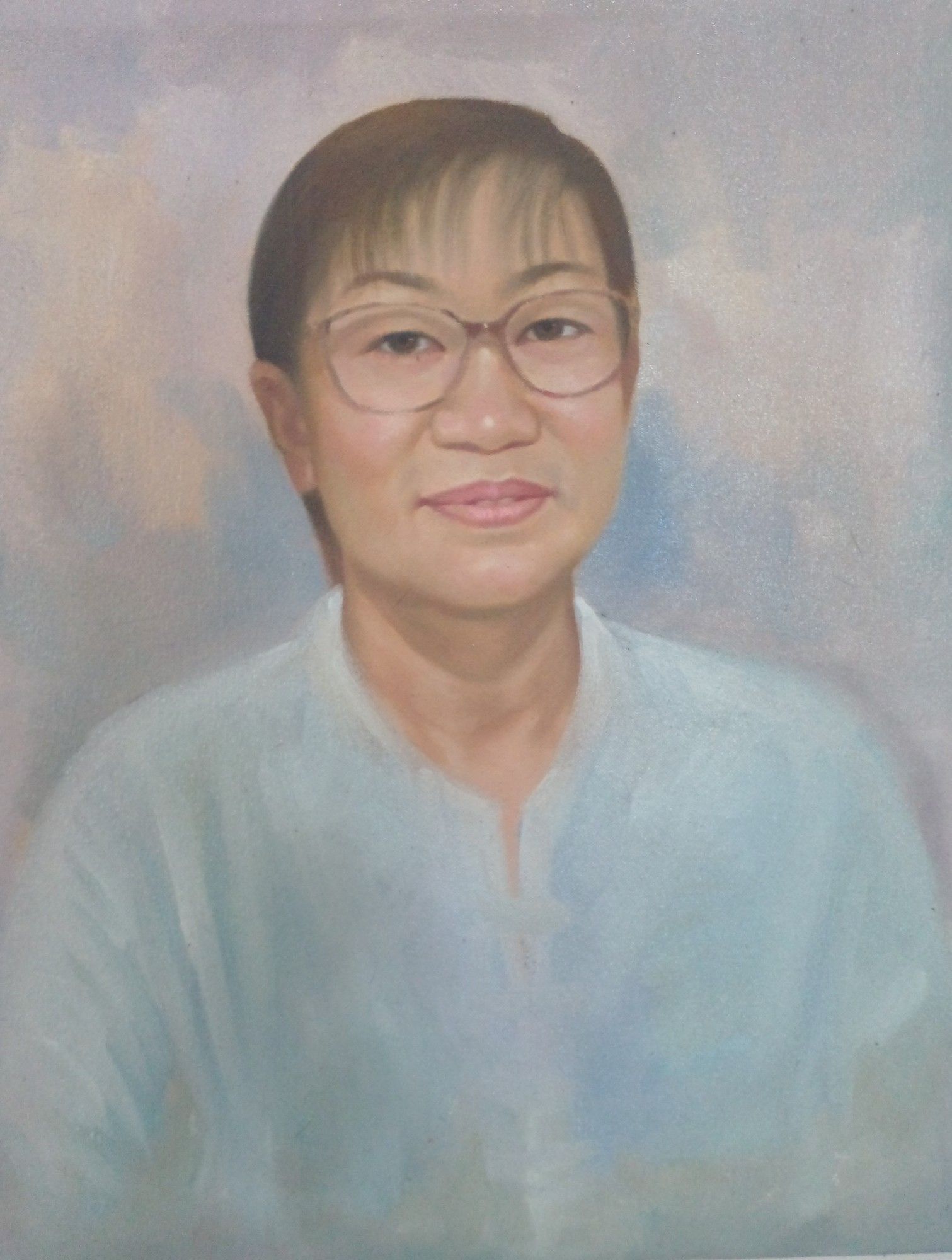 a painting of a woman with a short haircut and large-rimmed glasses wearing a powder blue shirt, against a grey-blue toned background