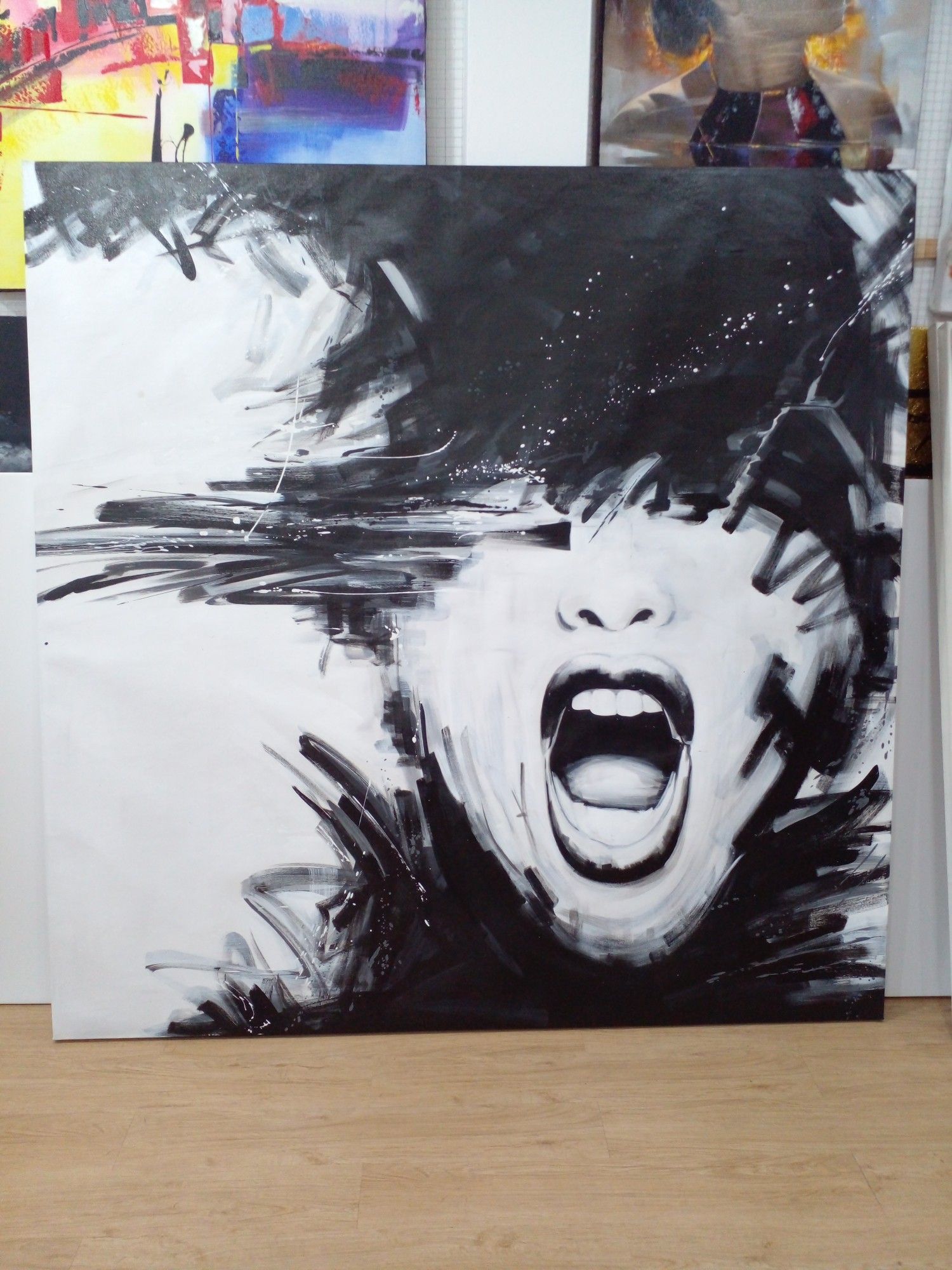 a photo of a painting of a screaming face on white background, lots of black slashy paint surrounds the face, the eyes are covered in black