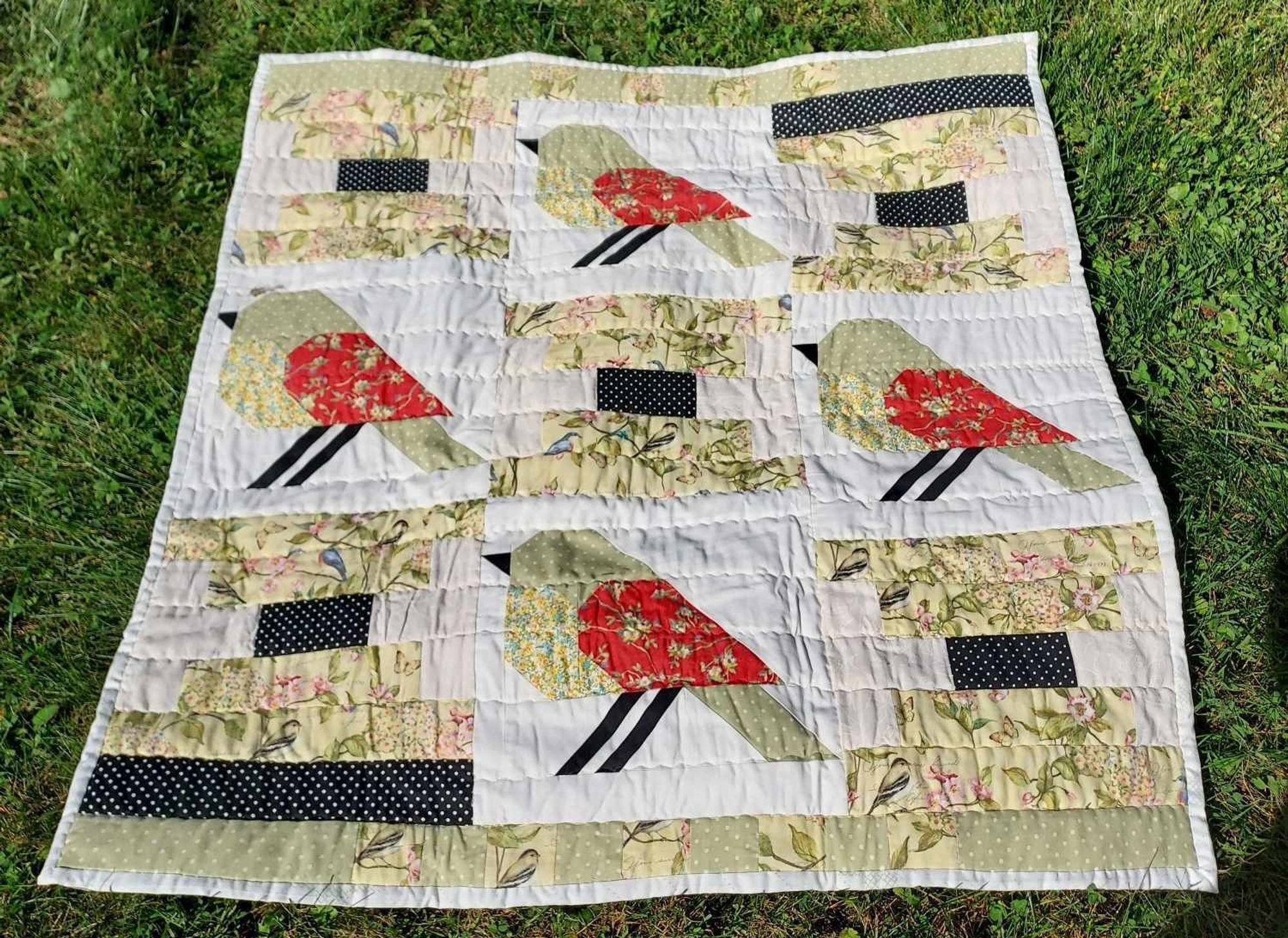 a quilt with a bird motif