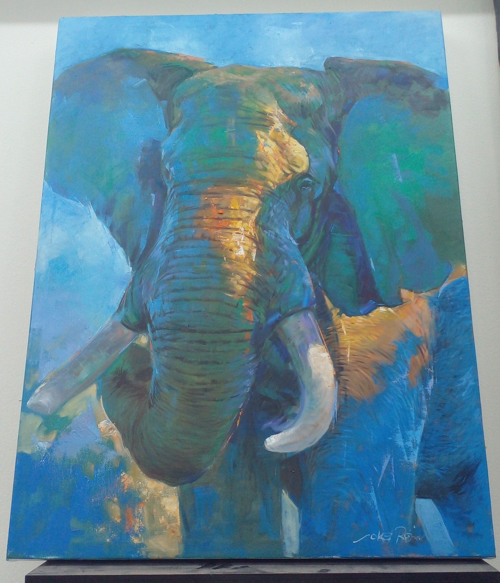 a realistic impressionist style painting of an elephant, tinted blue and green, some sunlight on its head and body