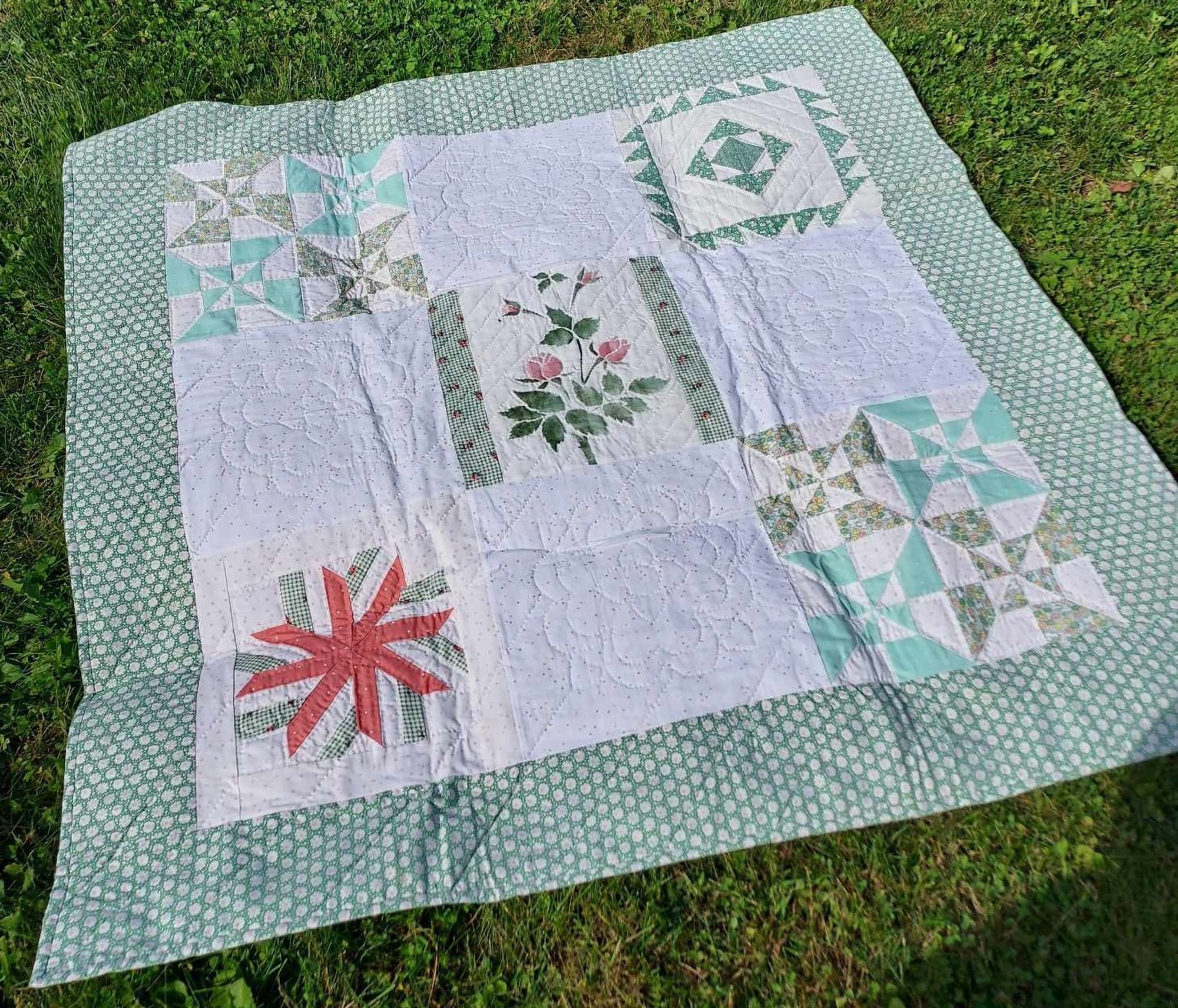 a white and green geometric quilt