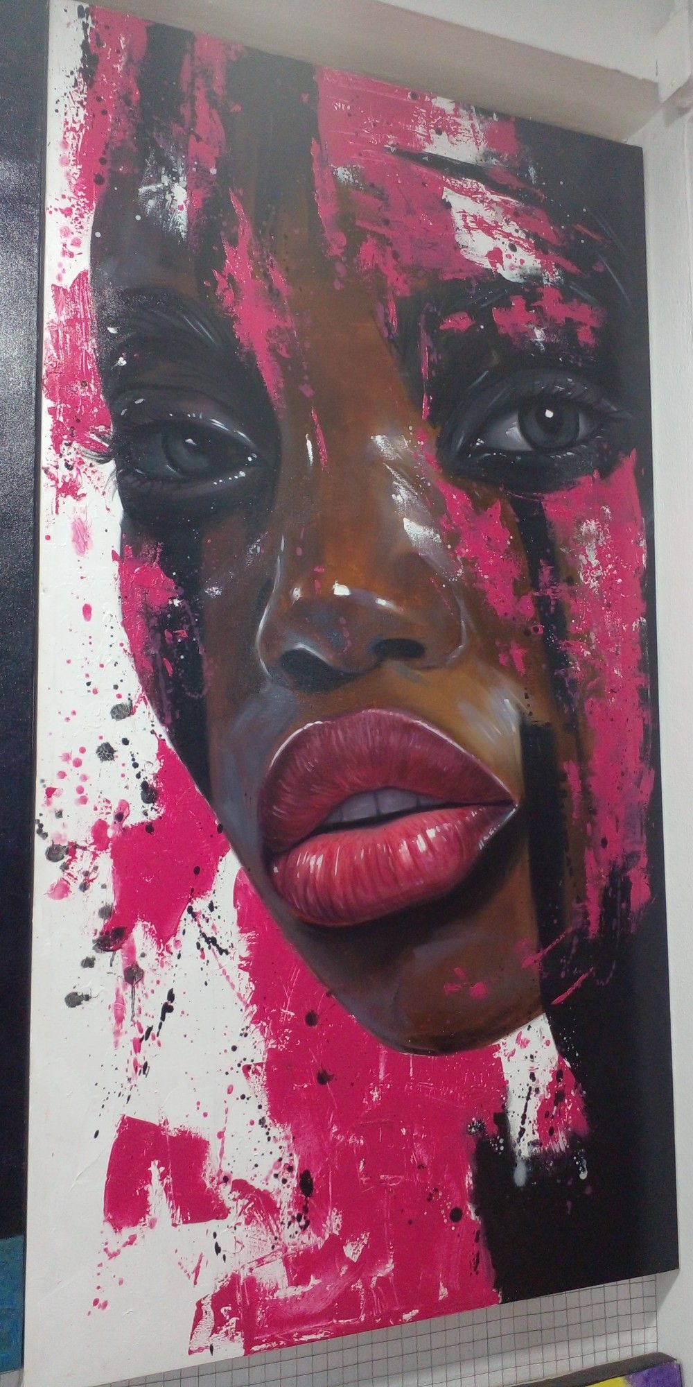 a painting, it is a feminine face, looking at the viewer, bright pink paint raining down, black paint as well, on a white background