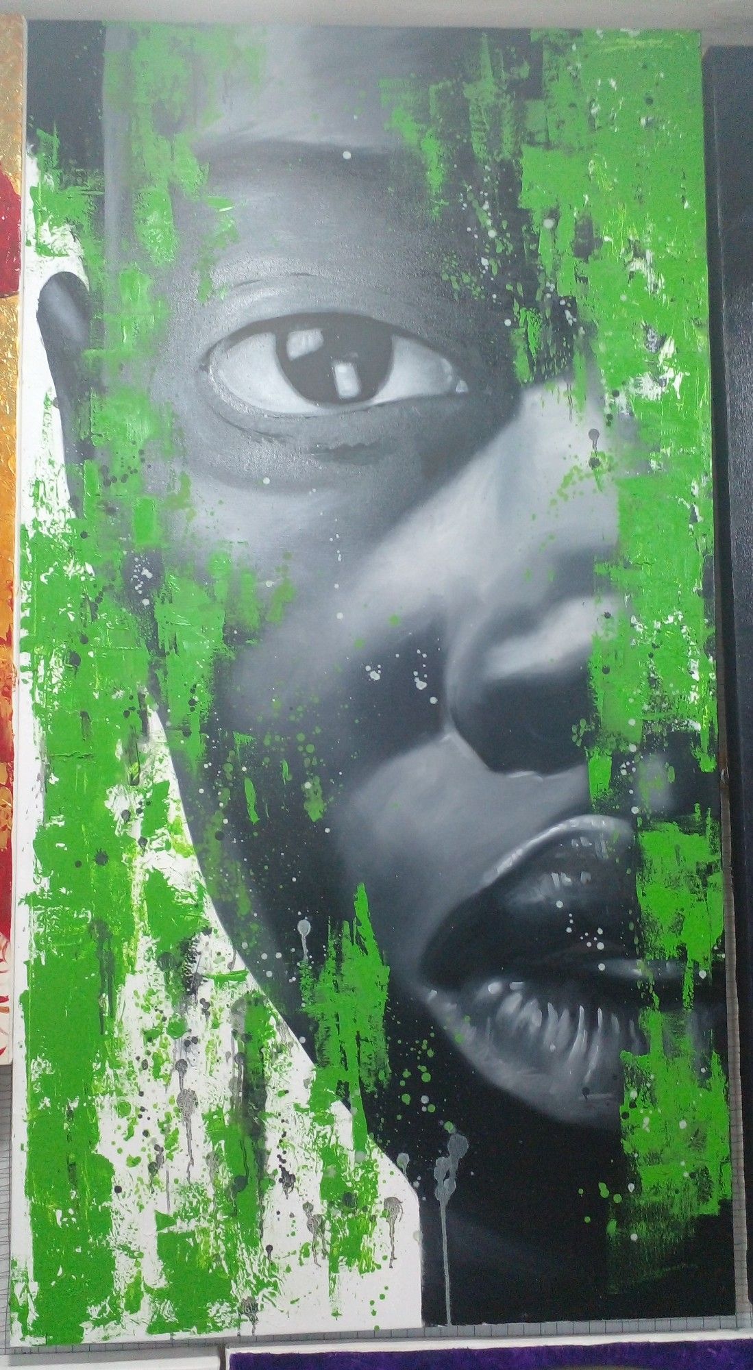 a painting, it is tall vertically, a face , a close-up, just half of it showing, looking at the viewer, green bright paint raining down from above in streaks