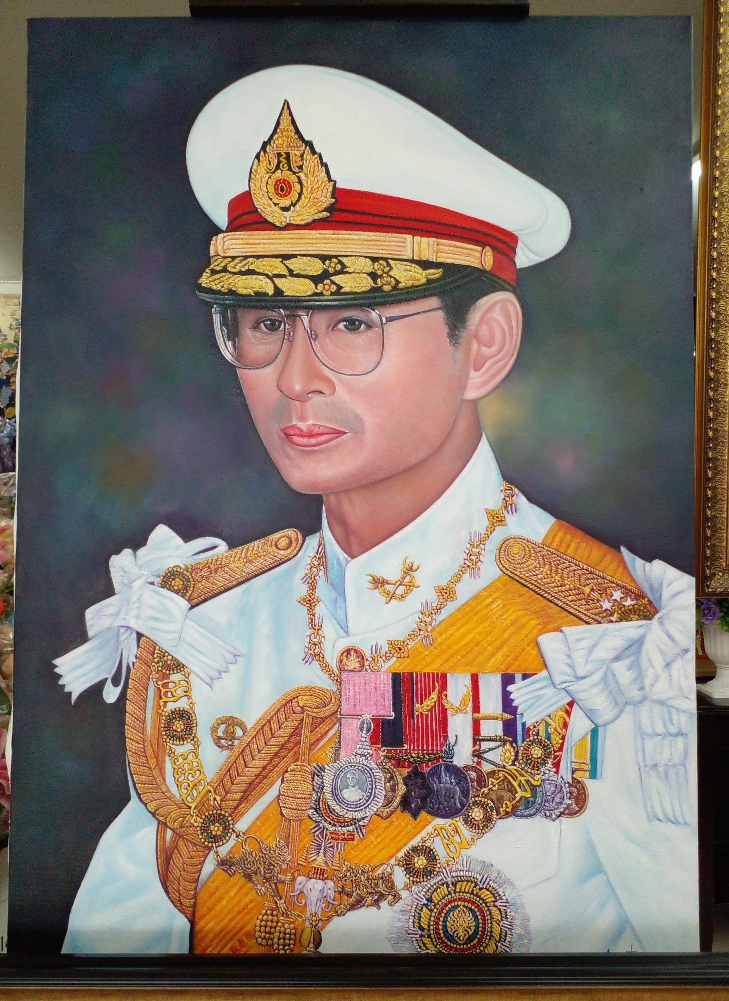 a painting of the previous king of thailand, seen from his chest up, wearing a his royal regalia, a large white hat on his head, he has many many medals covering his chest, gold epaulettes, a pleasant look on his face, looking to the left , a dark background