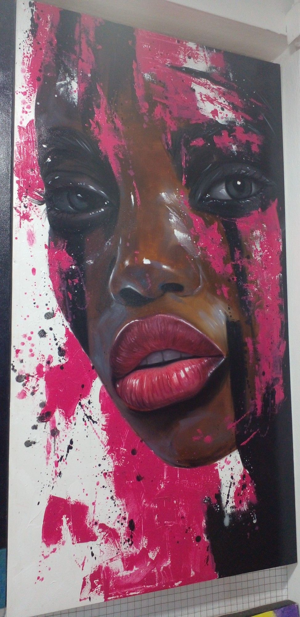 a painting of a face, looking at the viewer, strips of bright pink coming down over her face, black paint as well, over a white background 