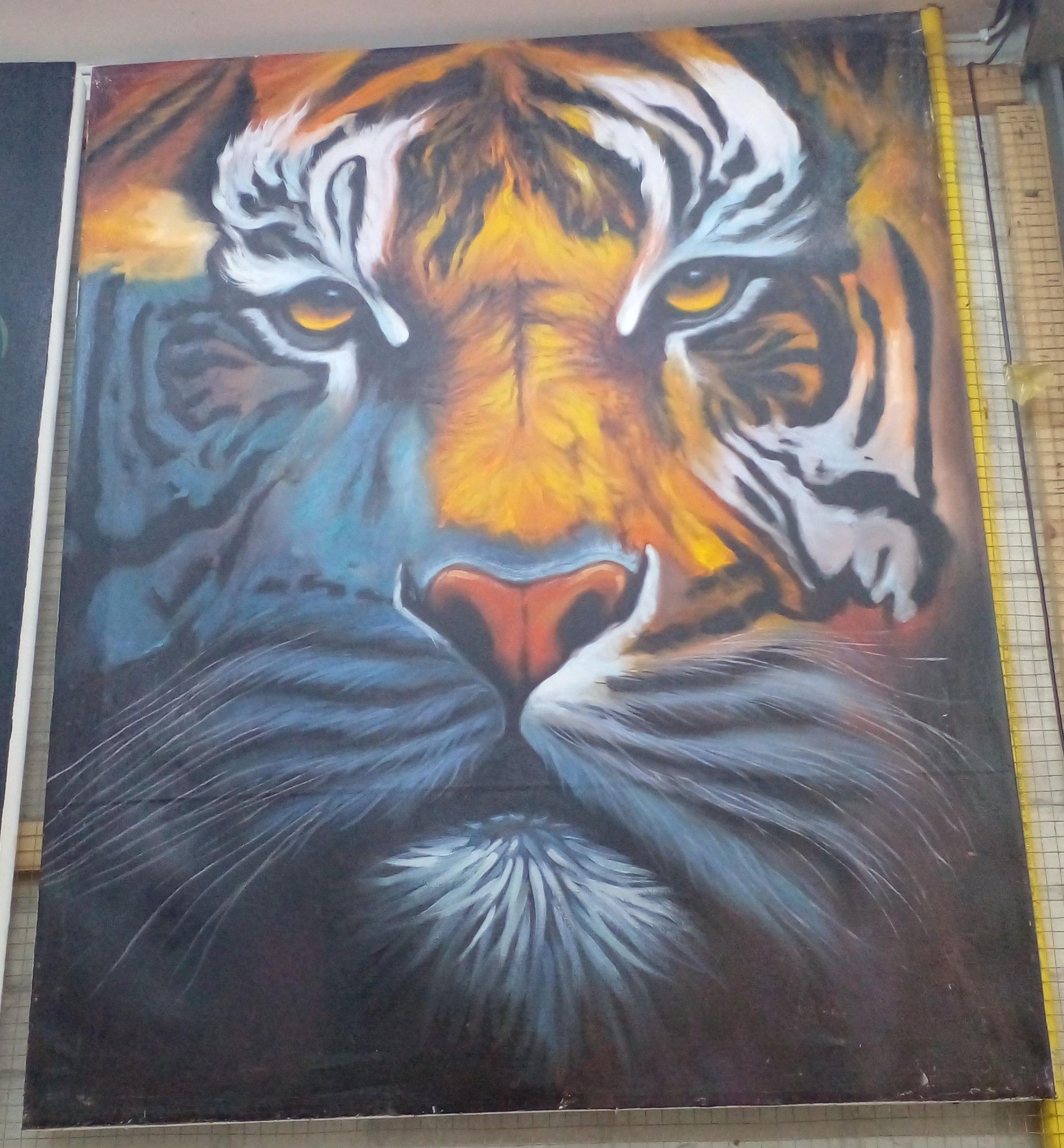 a painting of a tiger's face emerging from shadows , looking at the viewer