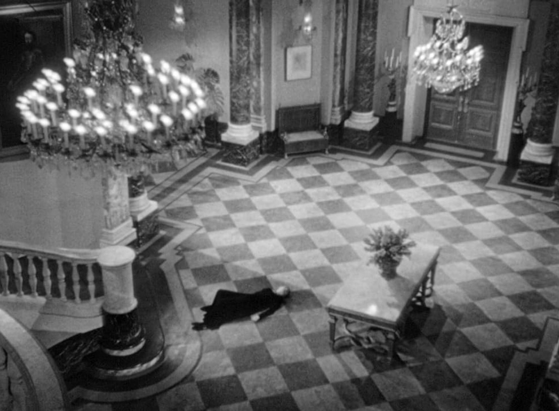 an image of a woman laying on the tiled floor of an elegant house, chandeliers hanging glowing