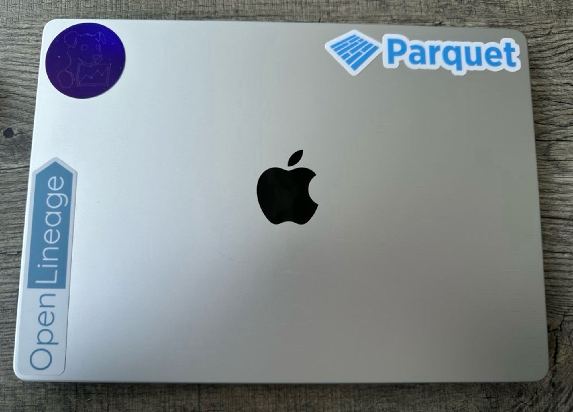 Mac laptop with Parquet, OpenLineage and Datadog stickers