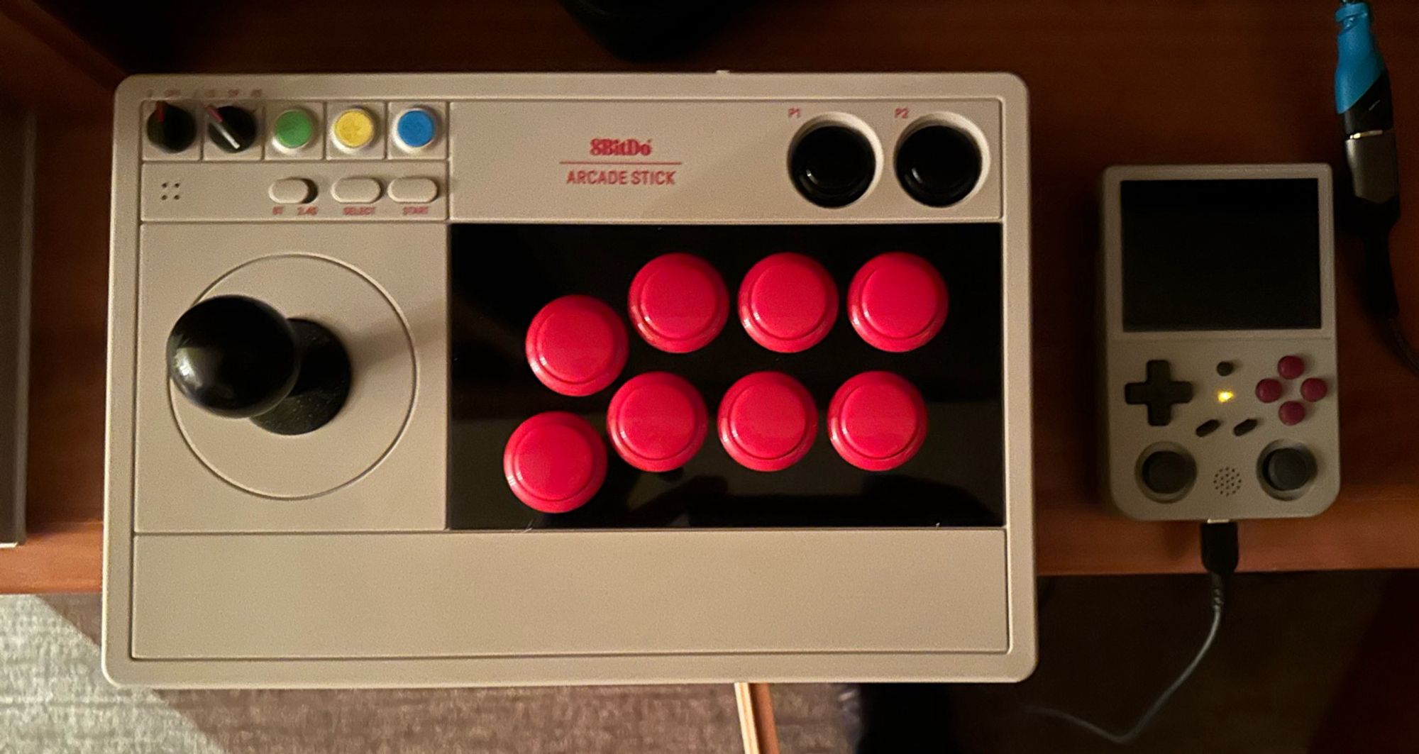 8bitdo arcade joystick next to anbernic portable console.