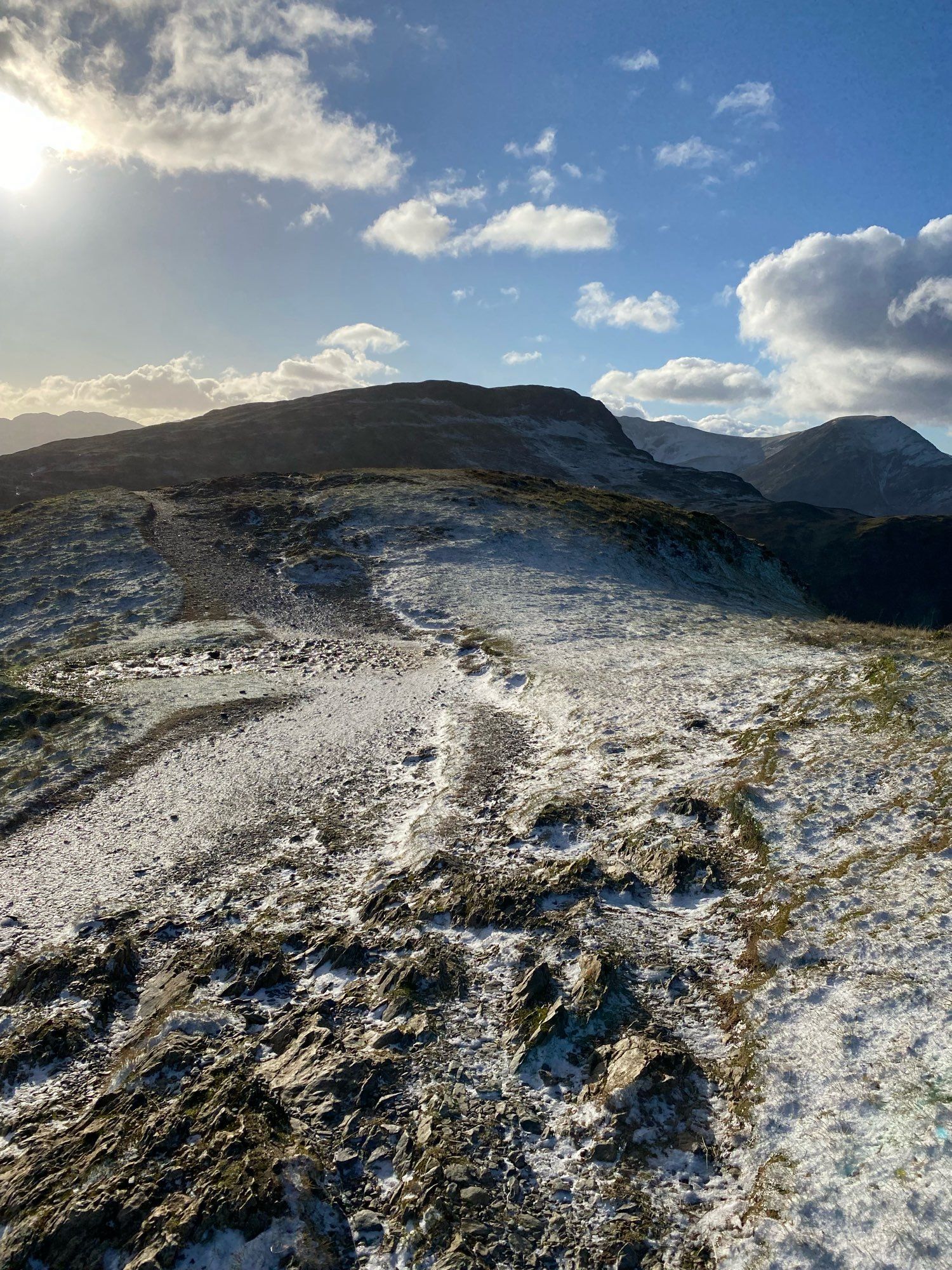 Top of Catbells in light snow and sunshine