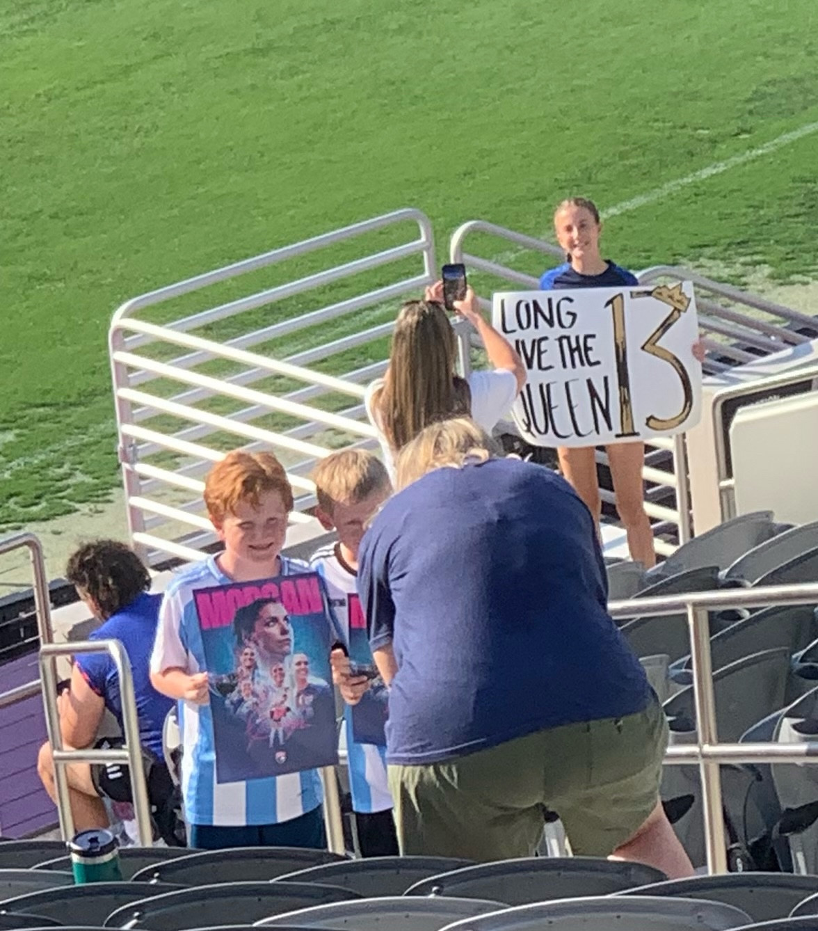 Kids at the Wave game getting picture taken with poster