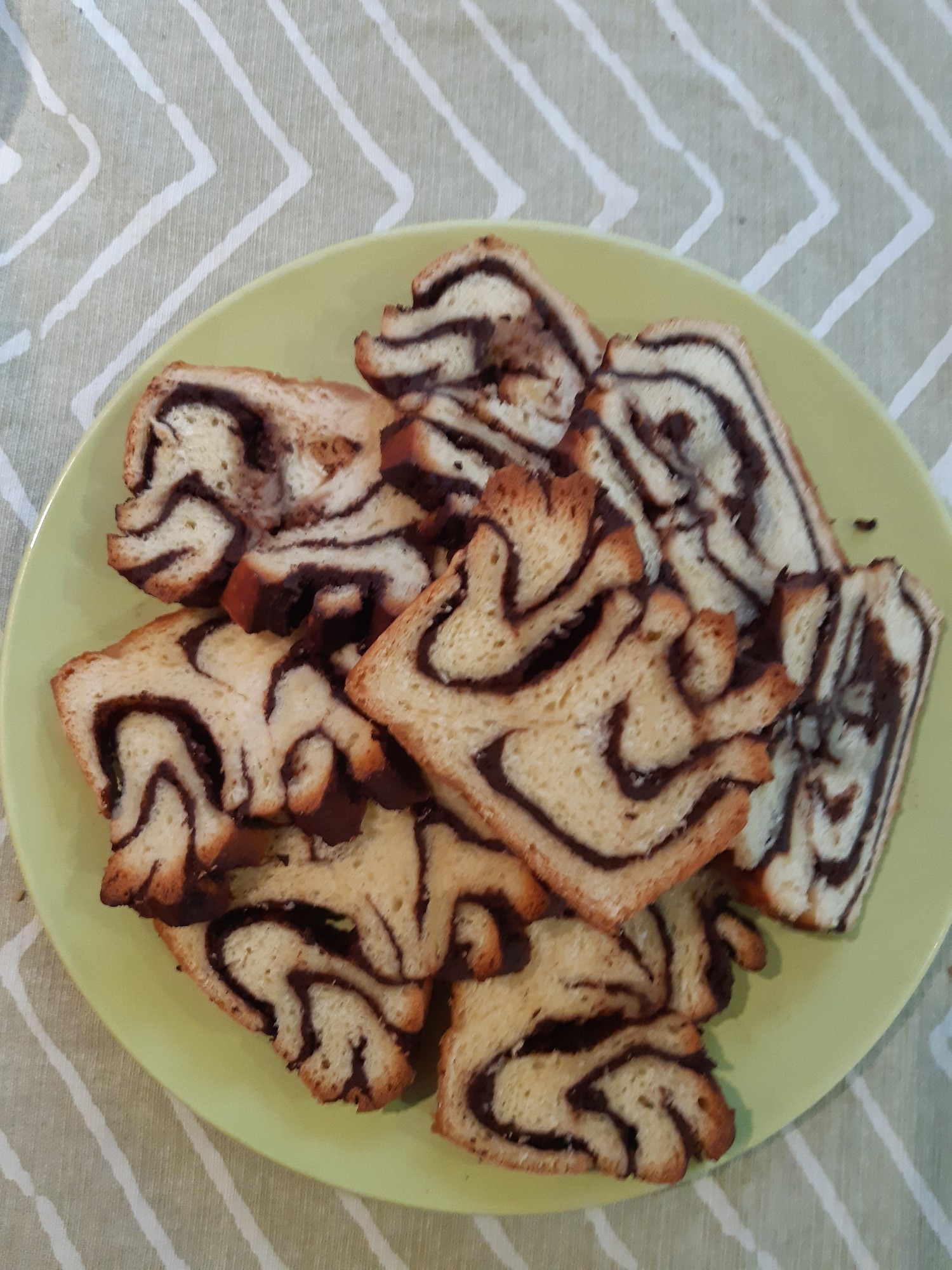 Slices of homemade babke on a green plate.